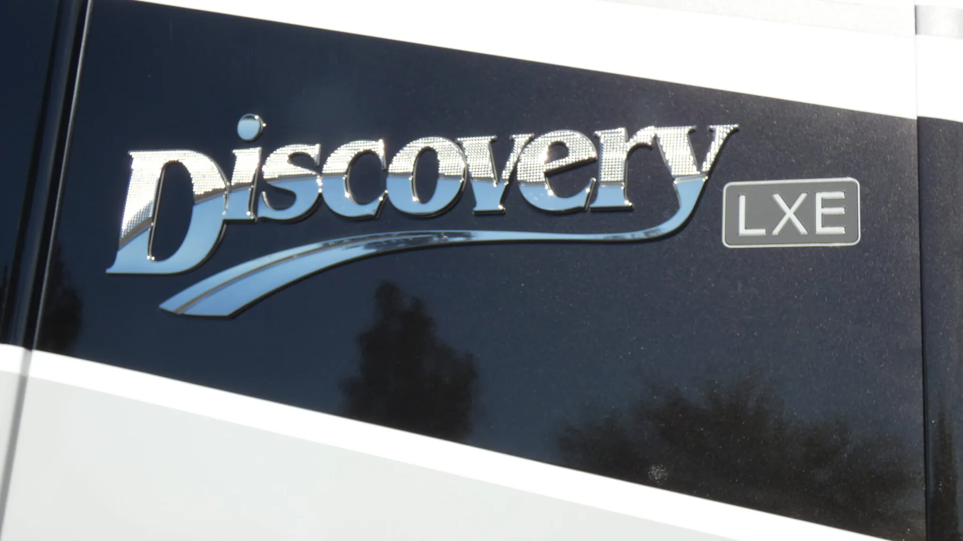 2026 Fleetwood Discovery LXE 40G — Close photograph visibly shows the Discovery LXE exterior branding on the RV body