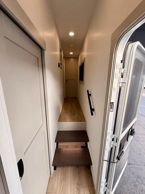 2026 Brinkley Model Z 3610 — Fifth wheel interior entry corridor with steps, raised hallway, open exterior door, and a closed interior door