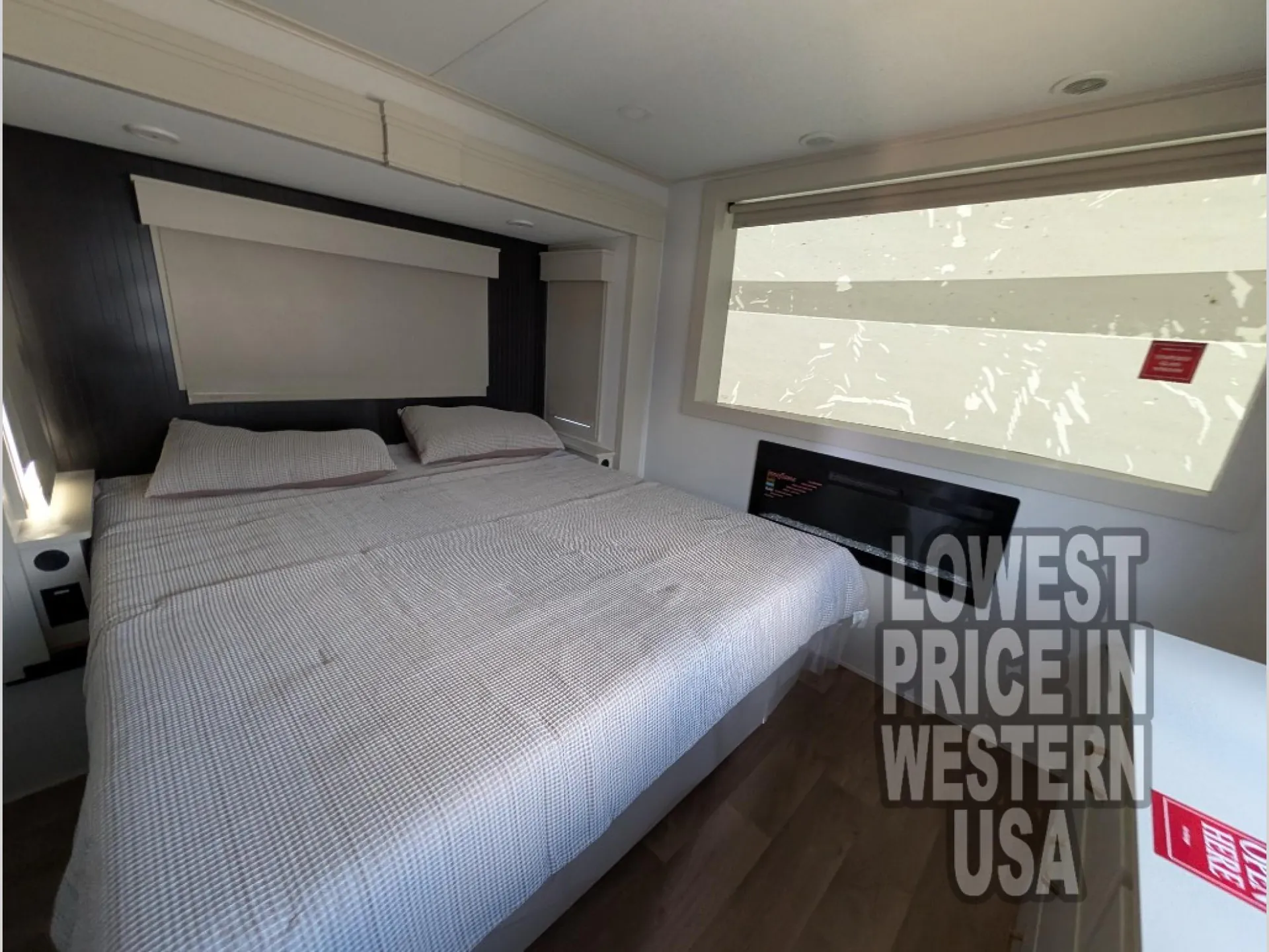 2026 Grand Design Foundation 42GD — Main bedroom close view of a made bed, headboard storage, window, and wall heater