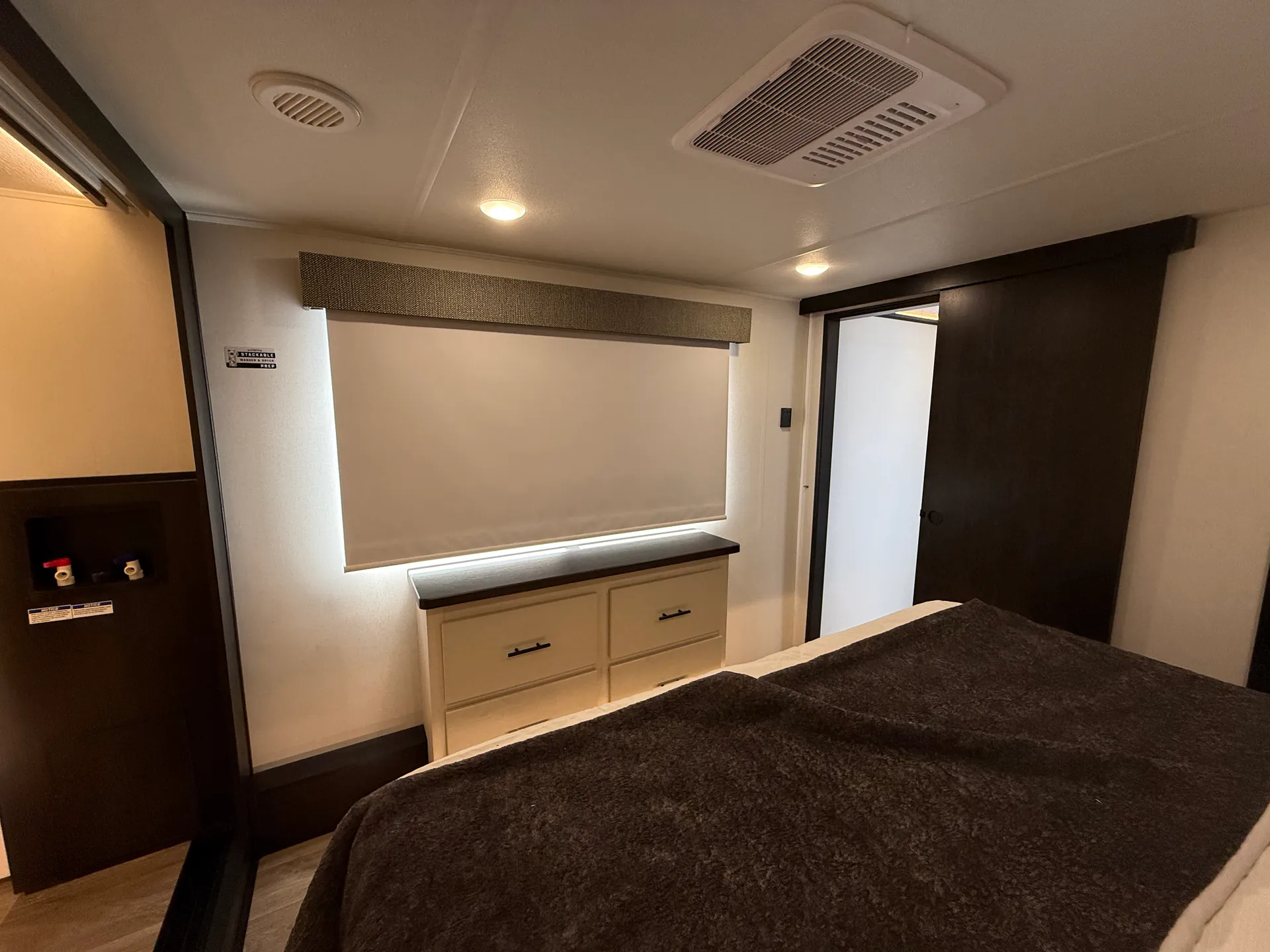 2027 Forest River Sabre 38RVHUNTER — Fifth wheel bedroom with bed, dresser, covered window, ceiling vent, and doorway