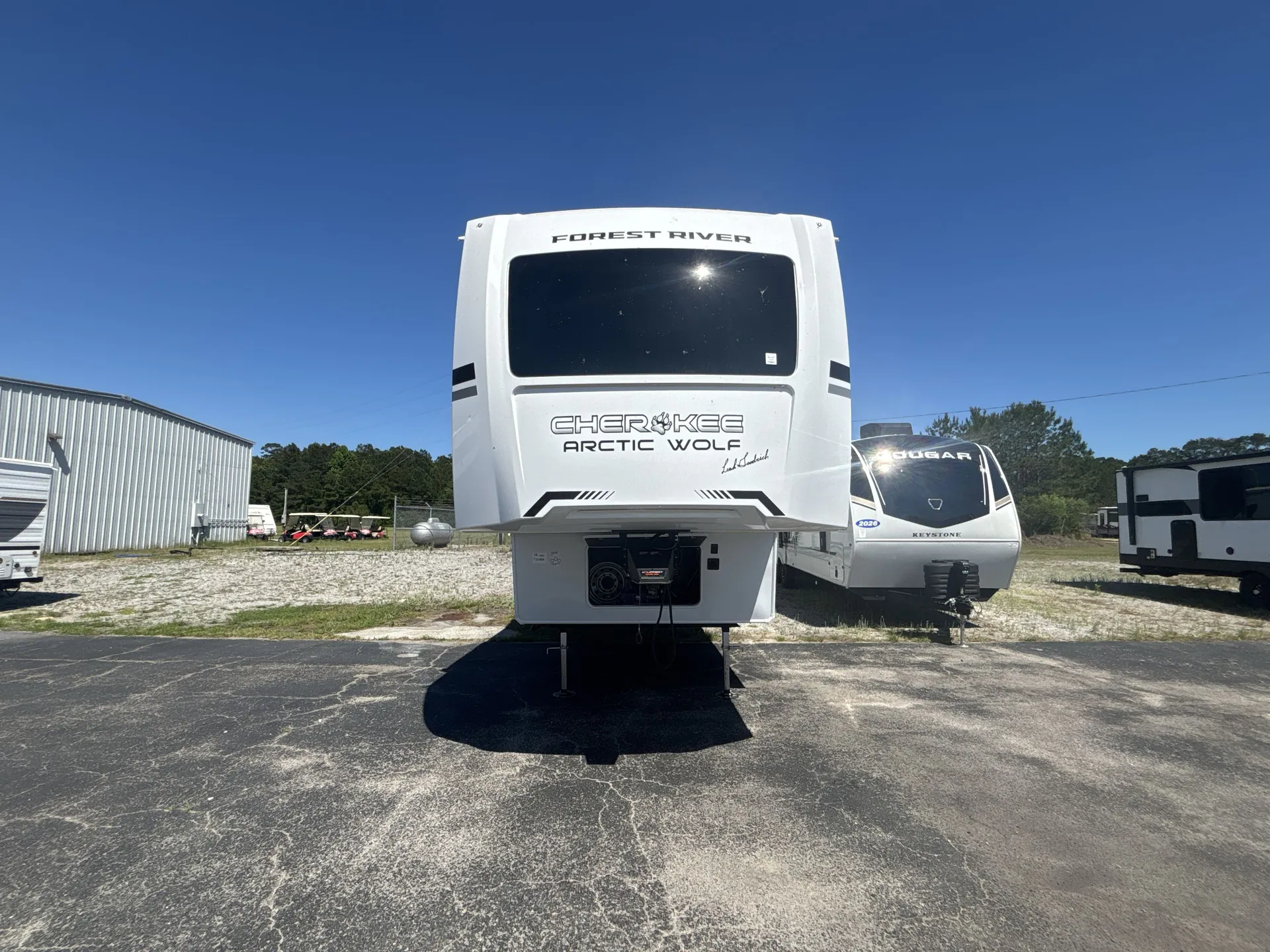 2026 Forest River Arctic Wolf 38LEAH.G — Front exterior photograph shows the RV front cap, branding, hitch equipment, and landing legs