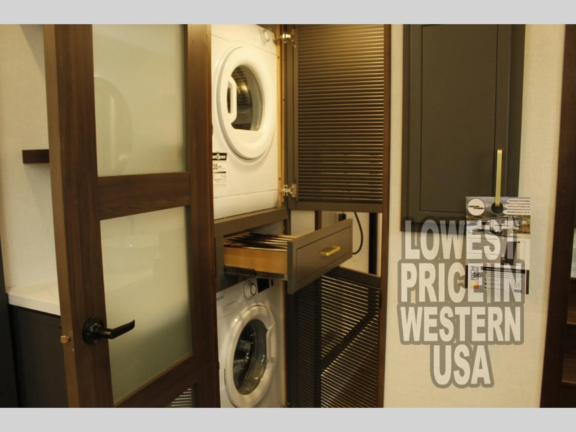 2026 Forest River Cedar Creek Cottage 41FWC — Stacked washer and dryer in a dedicated laundry cabinet with an open drawer and louvered doors