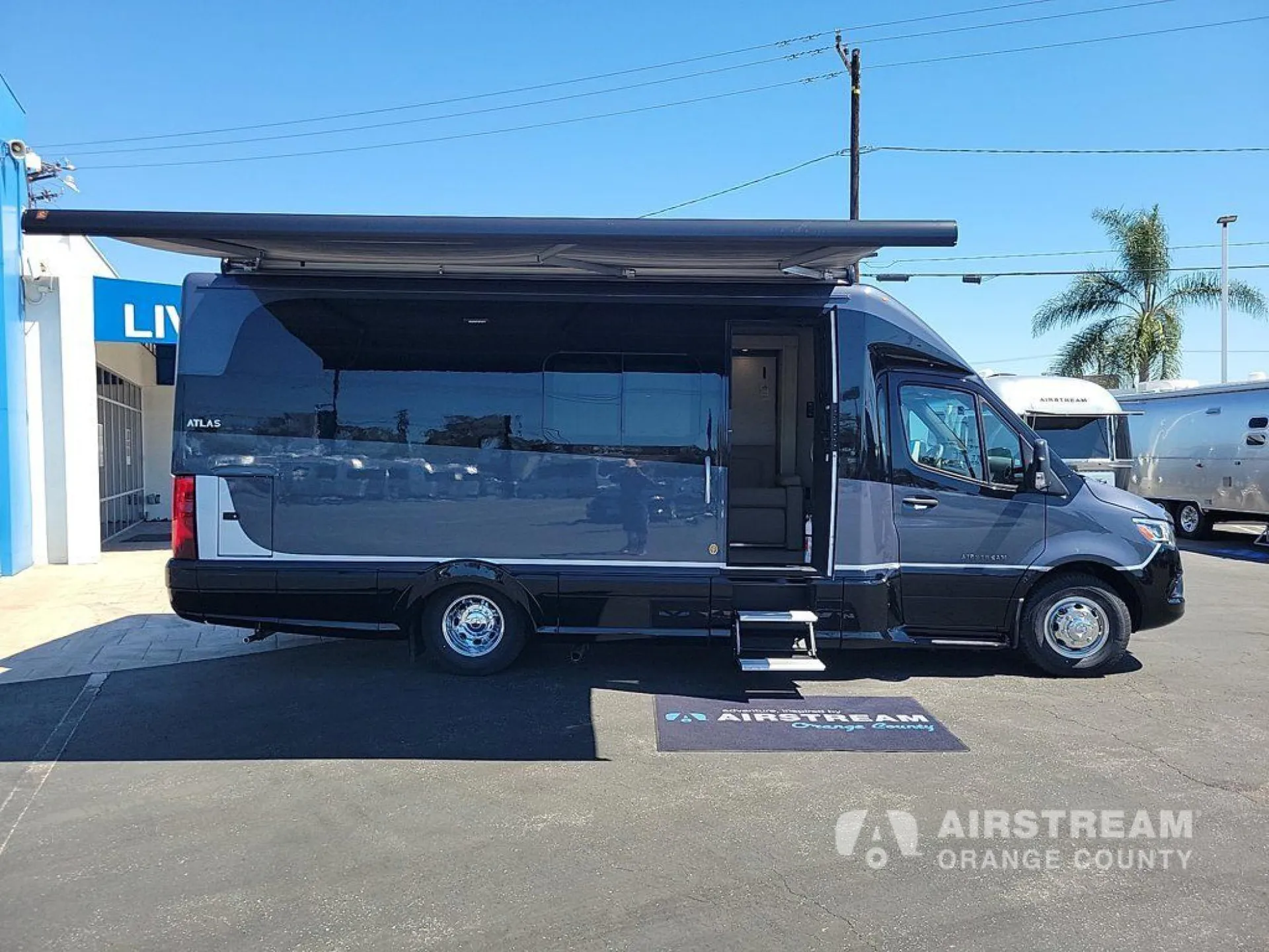 2026 Airstream Atlas Murphy Suite — The full exterior side profile of the motorhome with awning extended
