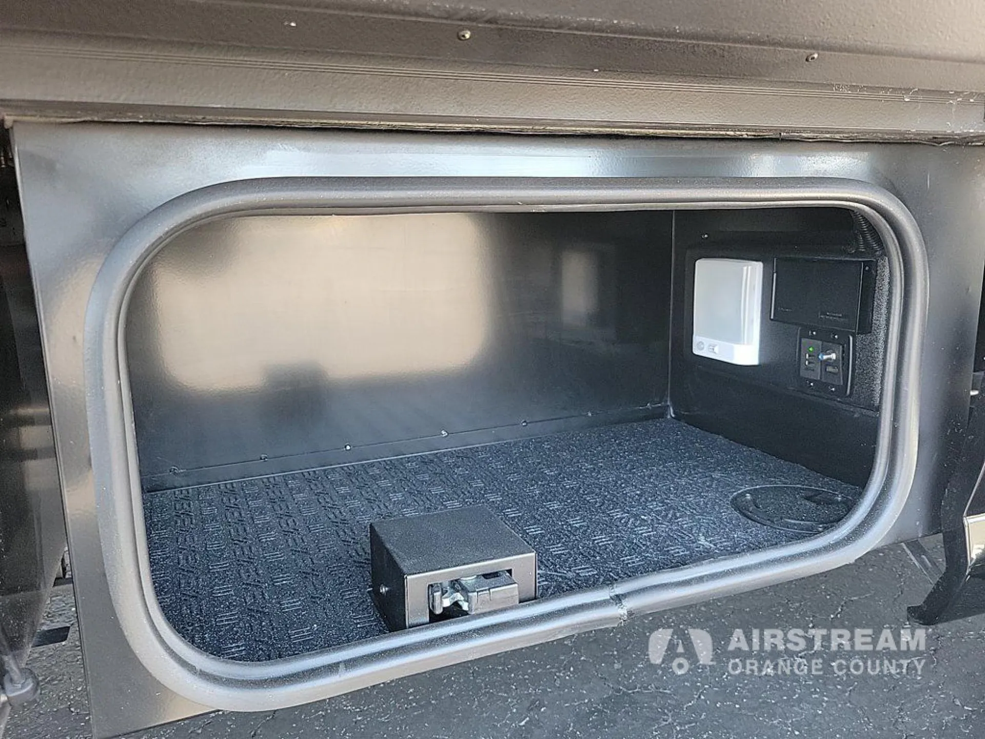 2026 Airstream Atlas Murphy Suite — Open exterior bay visibly contains electrical controls/outlets and wiring-related equipment