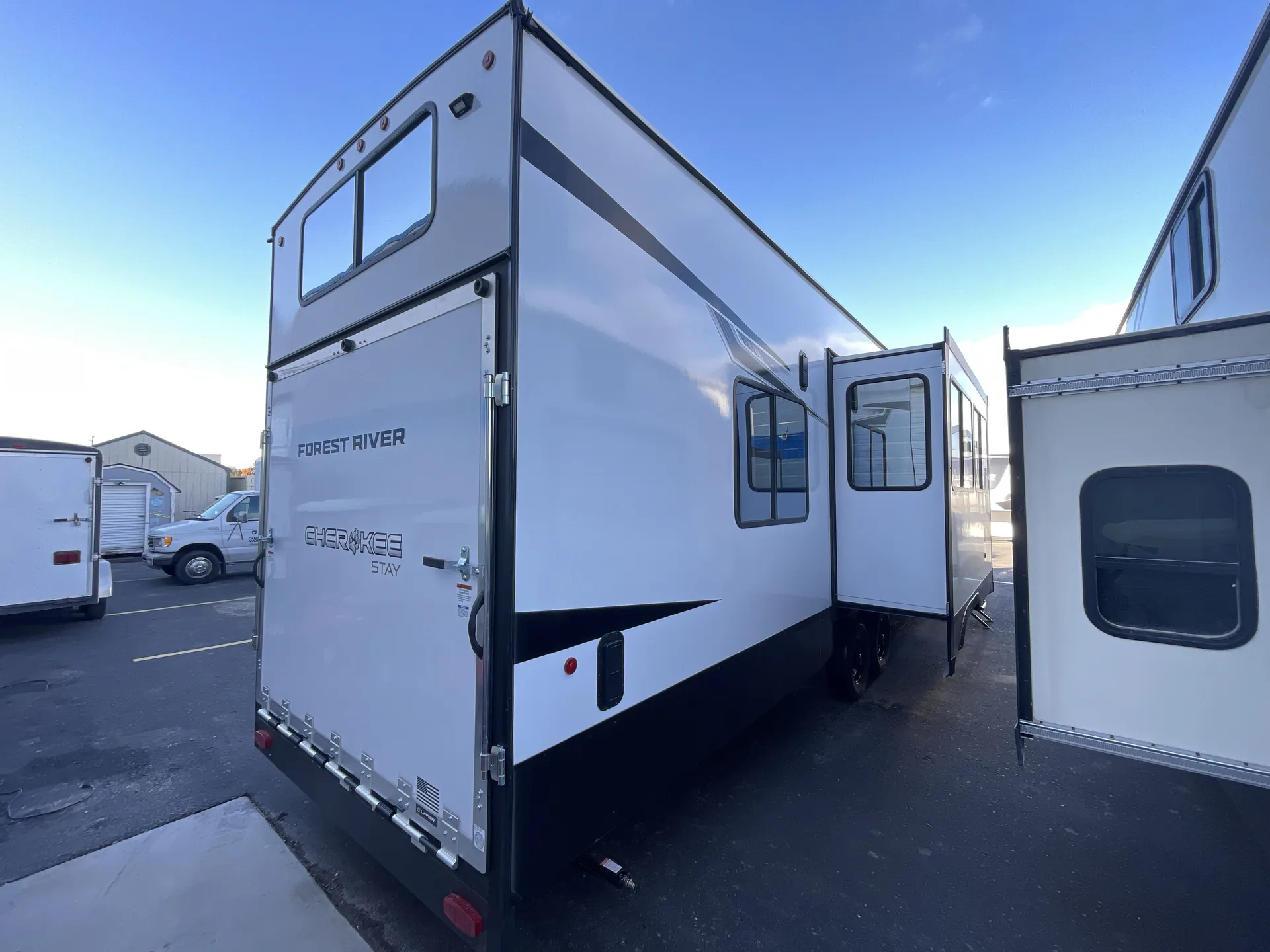 2026 Forest River Cherokee Wolf Pack 397STAY — Rear exterior photograph visibly shows the trailer rear ramp/garage door and exterior side walls