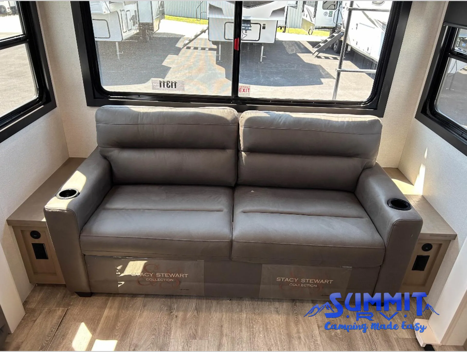2027 Jayco Eagle 355MBQS — Two-seat recliner sofa with cupholders positioned beneath large panoramic windows