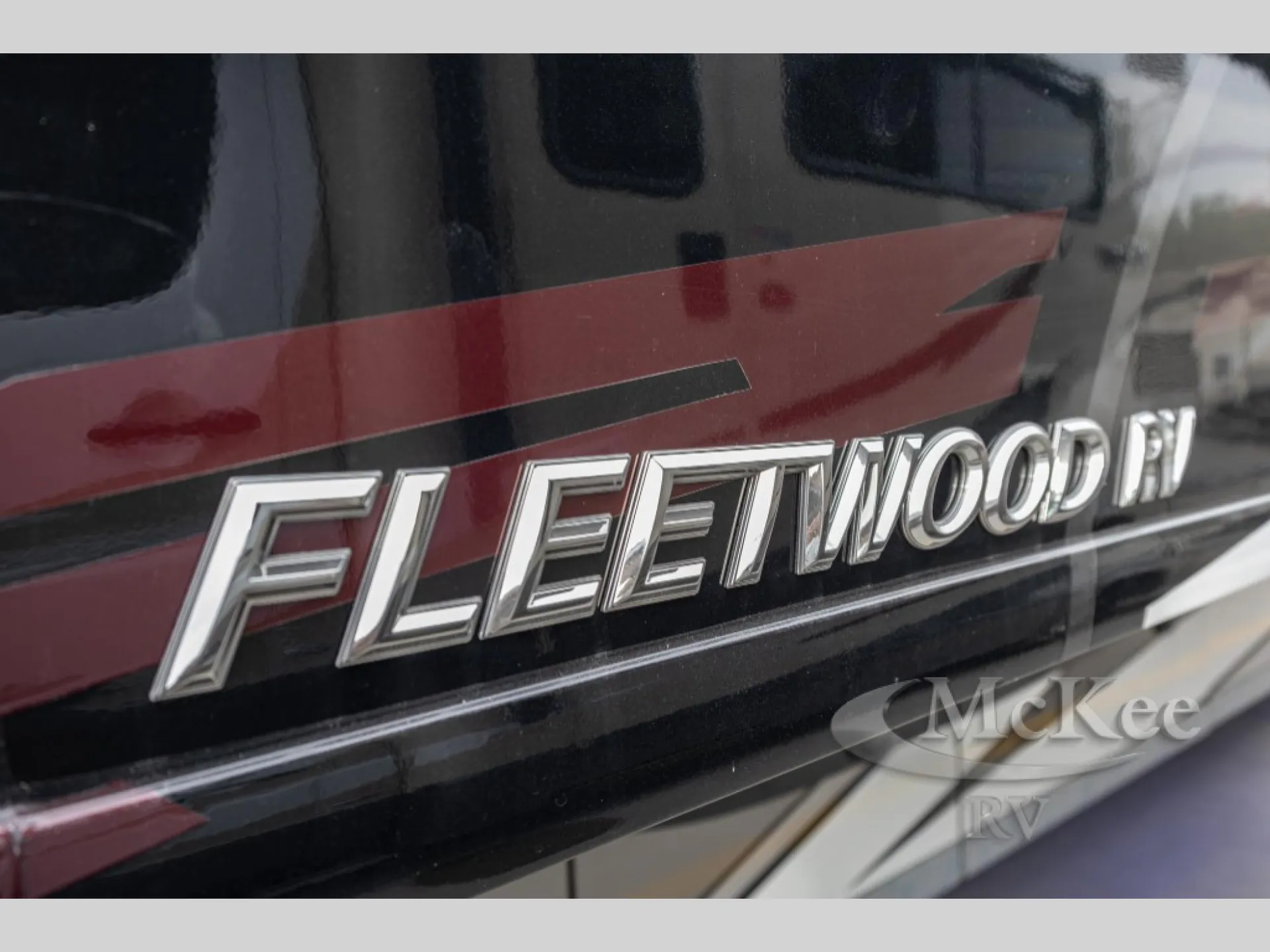 2027 Fleetwood Discovery LXE 40M — Close-up photograph visibly shows the exterior Fleetwood badge and body graphics