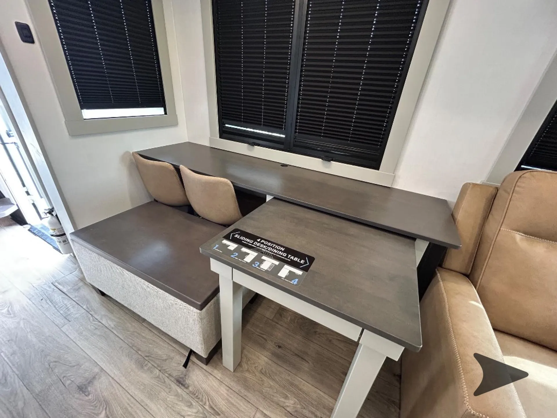2026 Brinkley Model Z 3515 — Fifth wheel dinette with bench seating, two chairs, sliding table surfaces, and covered windows
