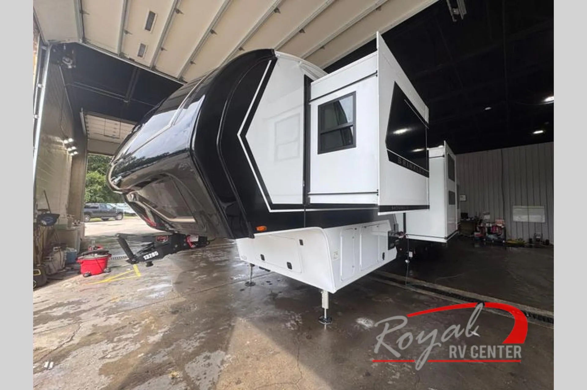 2026 Brinkley Model Z 3610 — The front exterior nose, hitch area, landing gear, and side slide-outs of the fifth-wheel RV