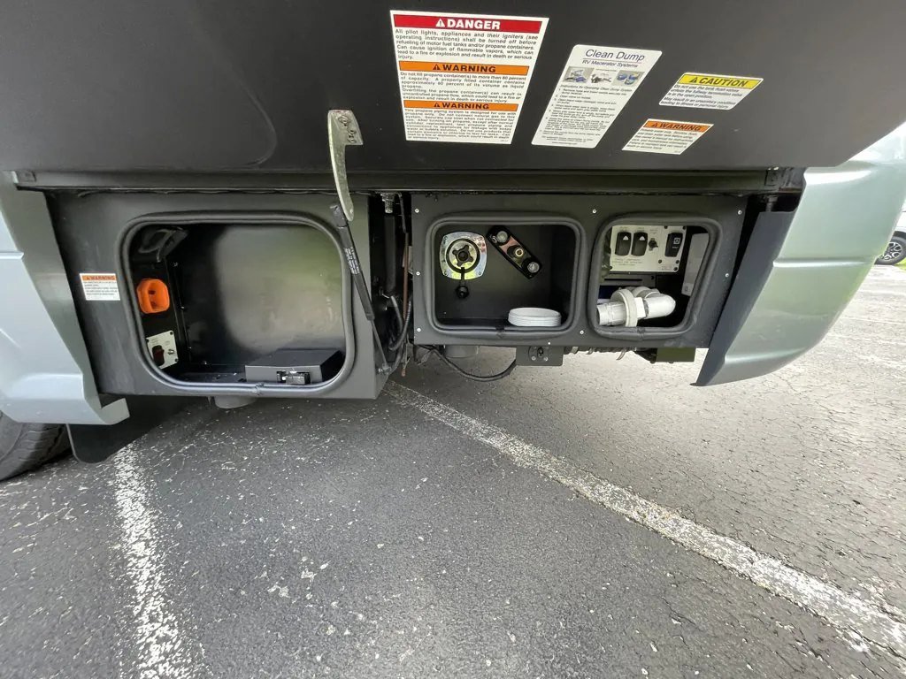 2026 Airstream Atlas Murphy Suite — Exterior service compartments visibly contain utility controls, fittings, and plumbing-related equipment