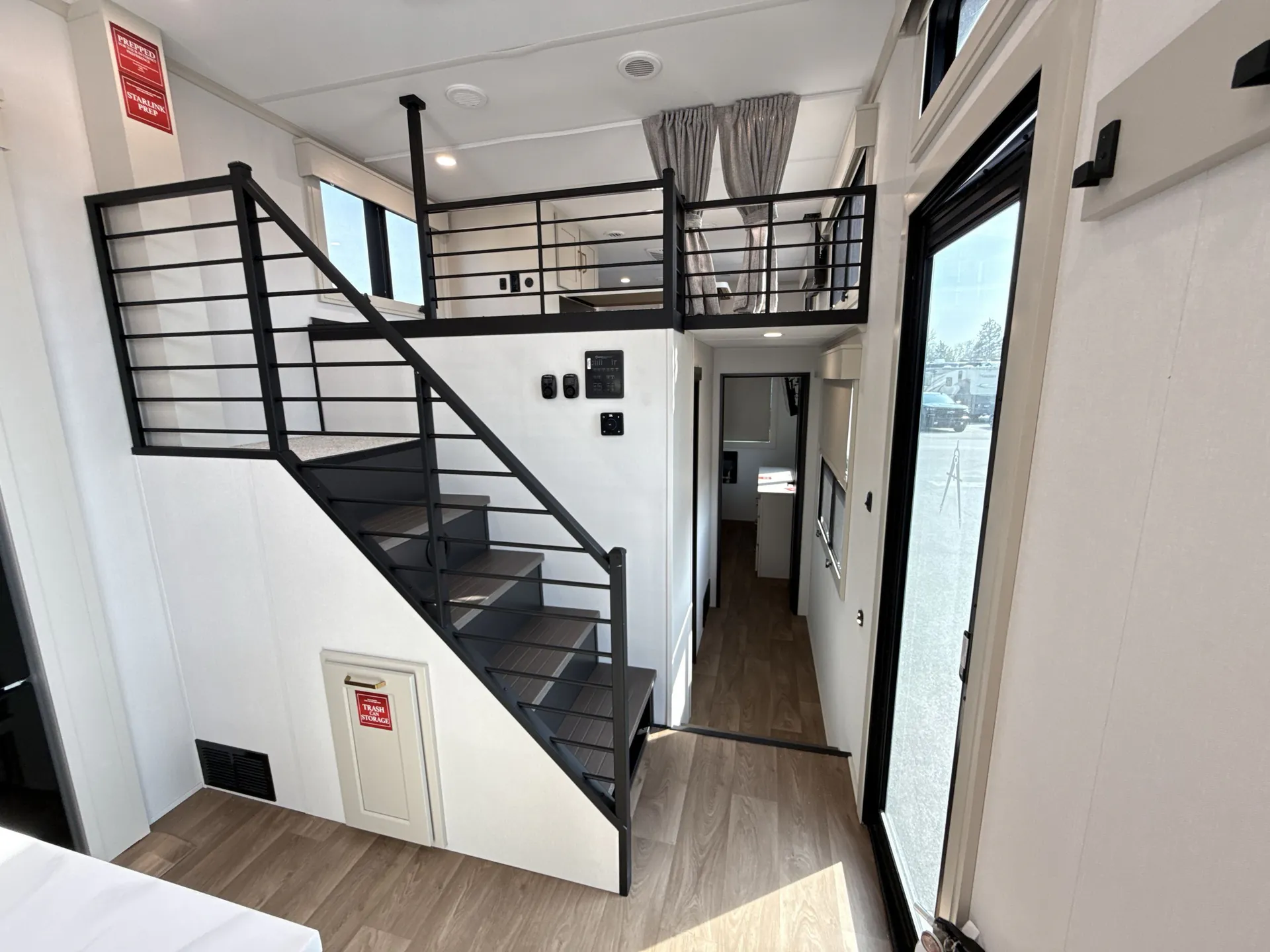 2026 Grand Design Foundation 42GD — Destination trailer interior showing an elevated loft platform with railings above a stairway and living area