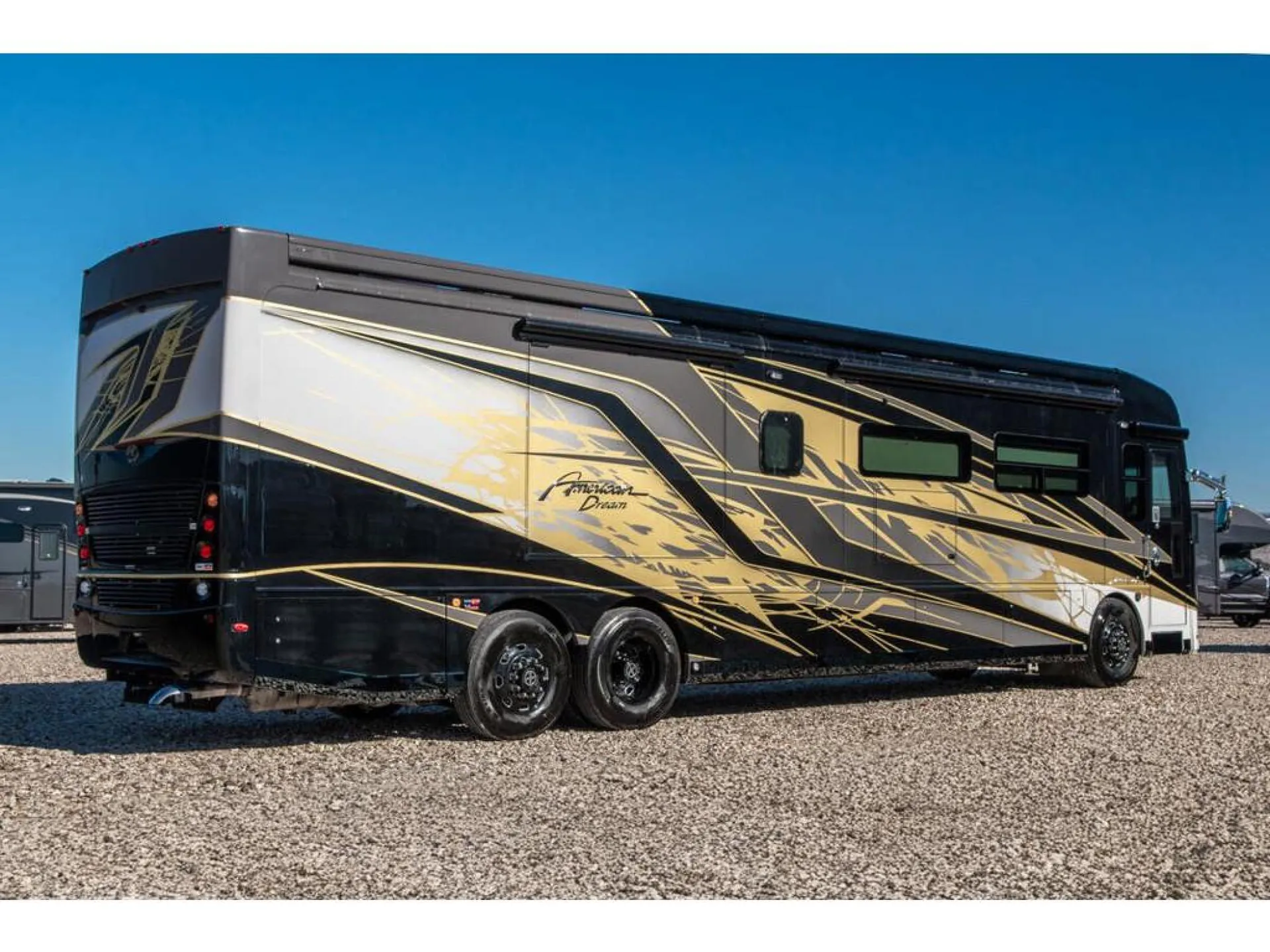 2026 American Coach American Dream 45A — Rear three-quarter exterior view of the motorhome, including body shell, wheels, and rear equipment