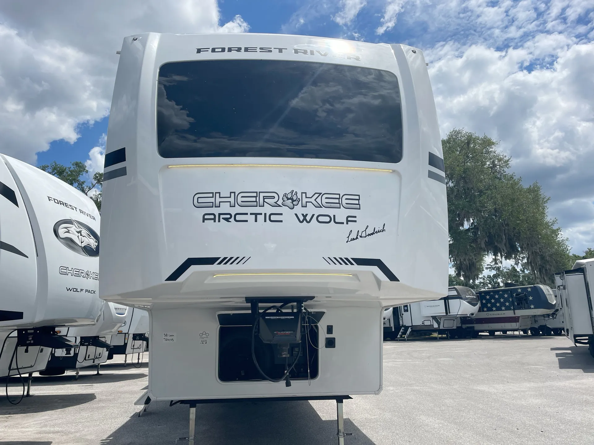 2026 Forest River Arctic Wolf 38LEAH.G — Rear-facing exterior view of the fifth-wheel front cap with the hitch assembly and connected mechanical equipment visibly exposed