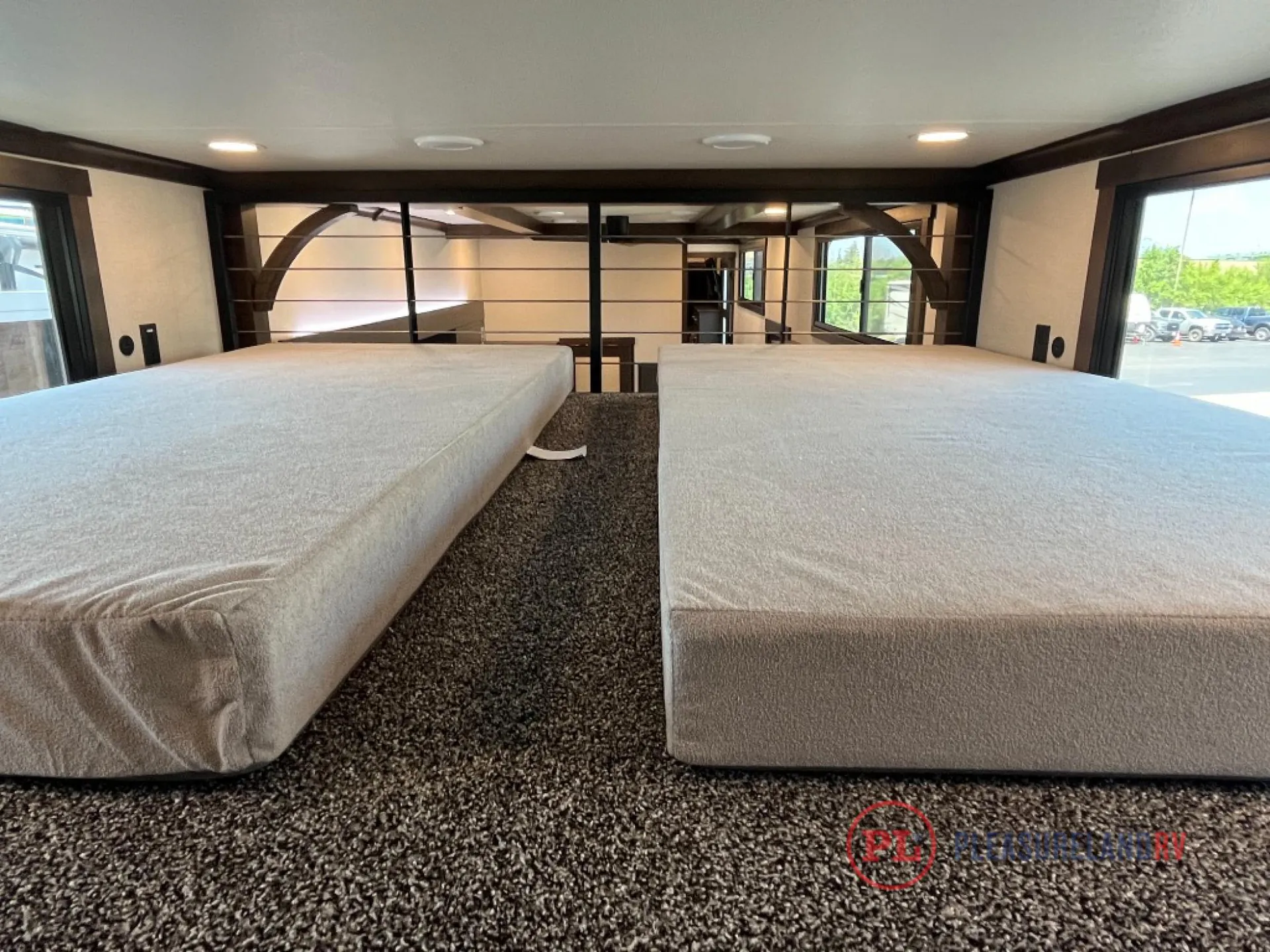 2025 Forest River Cedar Creek Cottage 41FWC — Two mattresses form an elevated loft sleeping area above the fifth wheel’s main living space