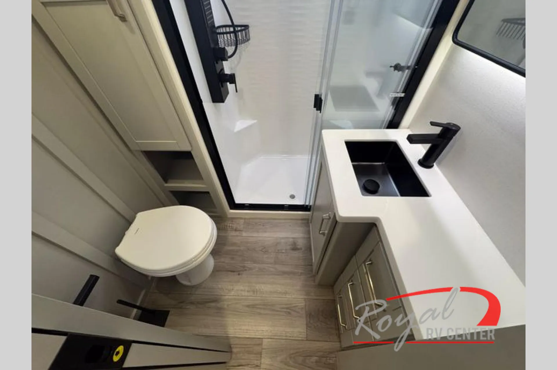 2026 Brinkley Model Z 3610 — Fifth-wheel bathroom with toilet, glass shower, black shower fixtures, vanity, sink, and lower cabinets