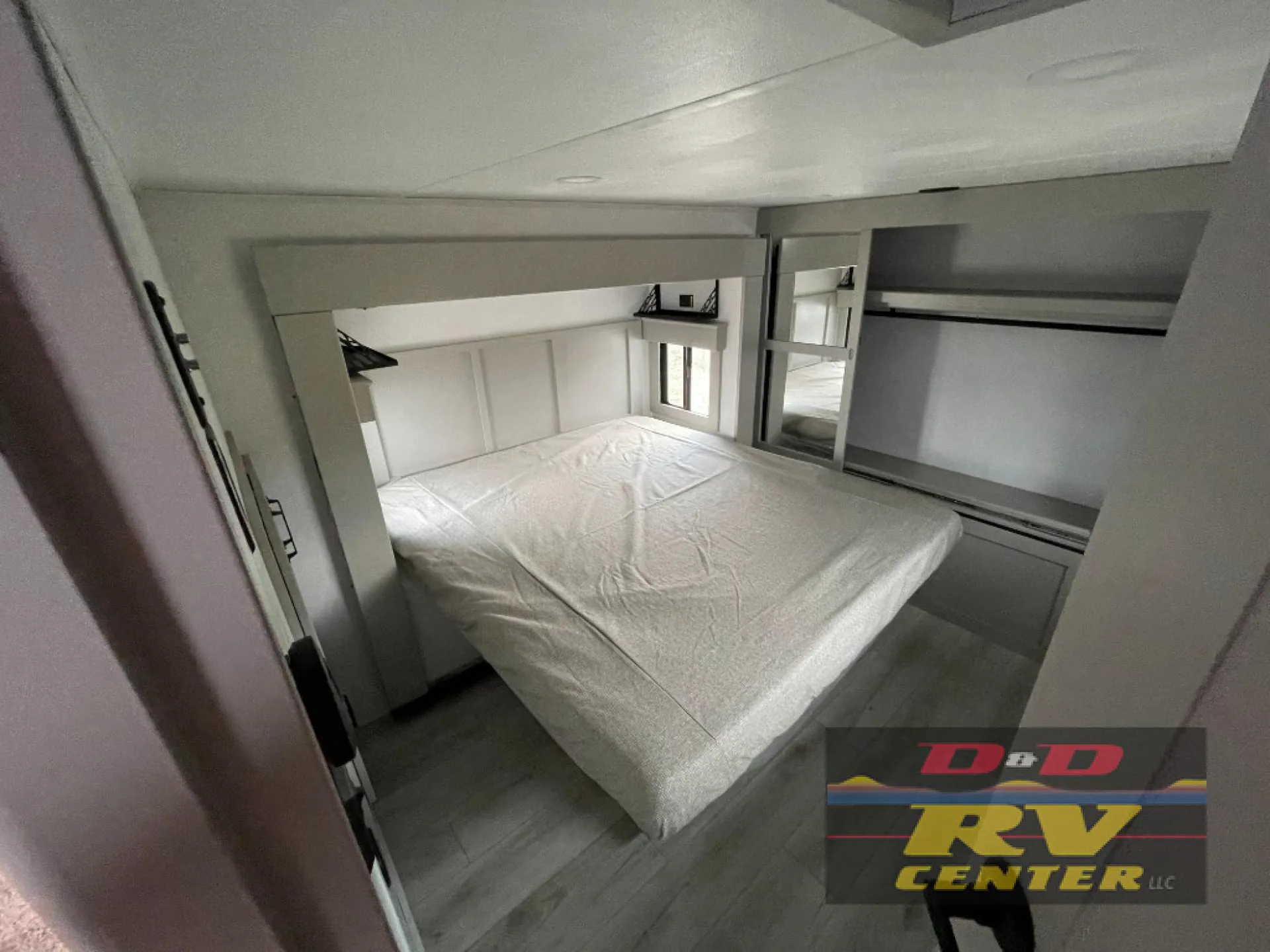 2026 Keystone Montana High Country 377FL — Main bedroom with a large mattress, overhead storage, side shelving, wardrobe, and windows