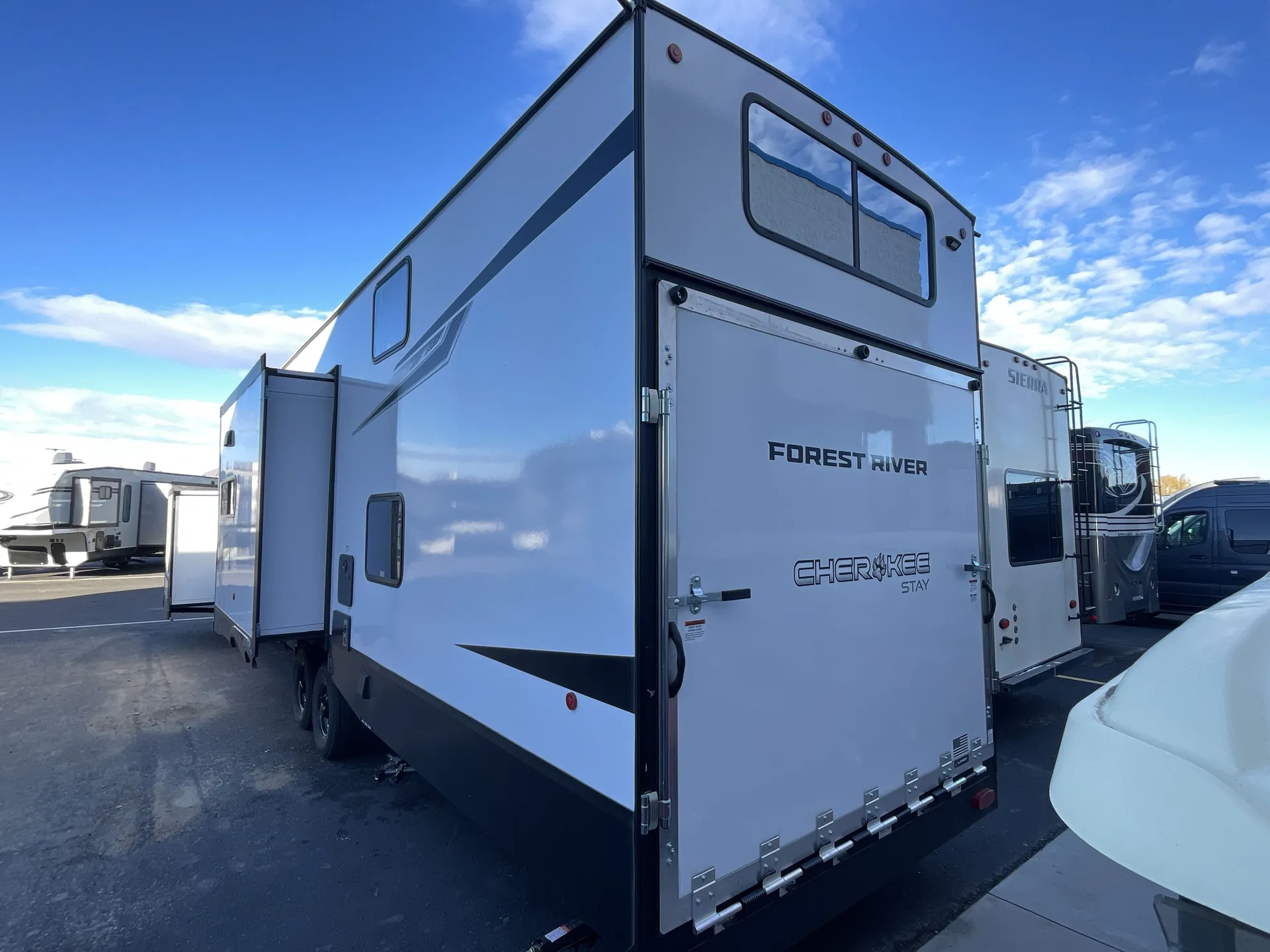 2026 Forest River Cherokee Wolf Pack 397STAY — Rear three-quarter exterior photograph clearly shows the large rear ramp/garage door and trailer exterior