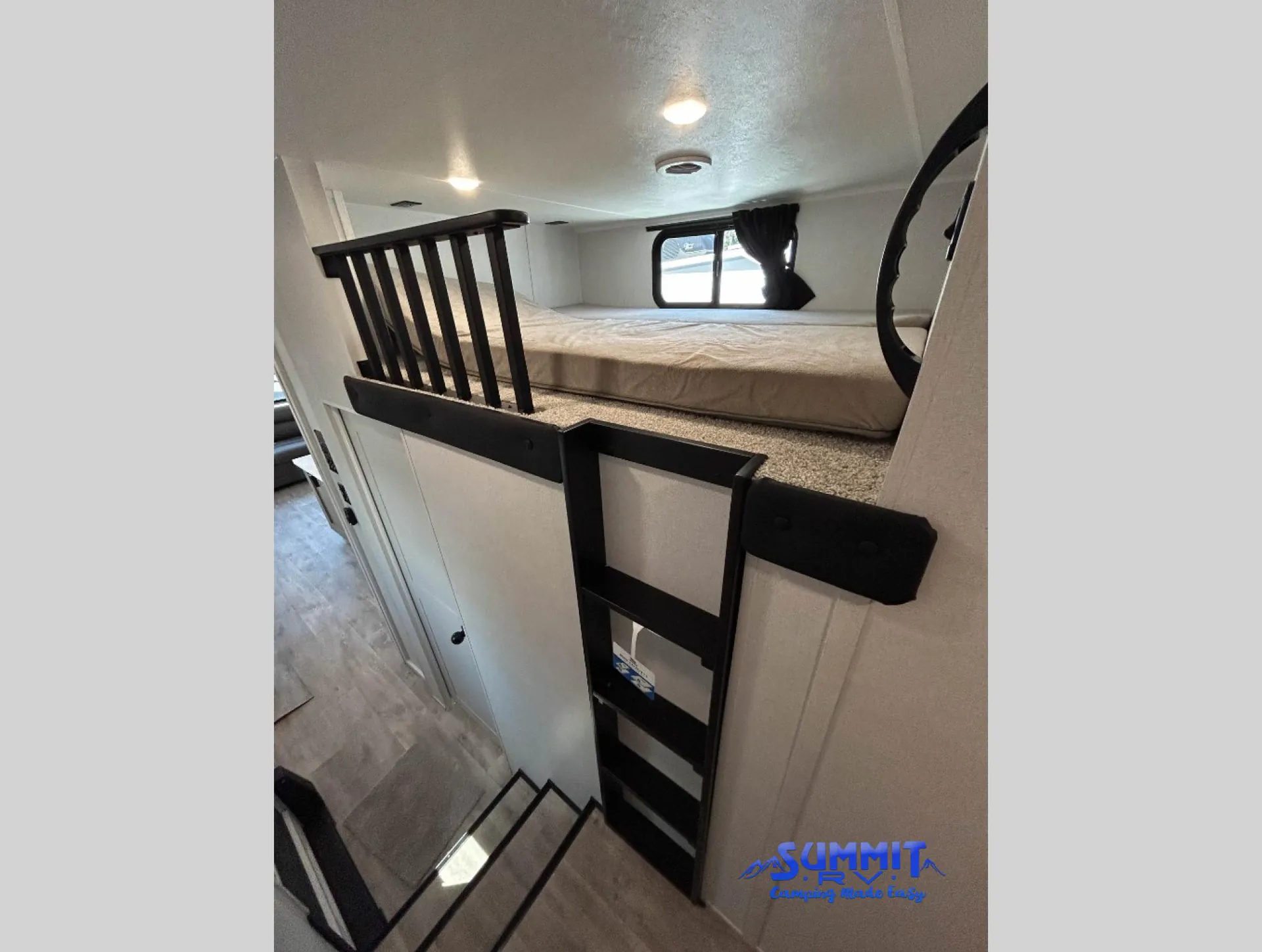 2027 Jayco Eagle 355MBQS — Elevated sleeping platform with mattress, guardrail, ladder, and open floor space below