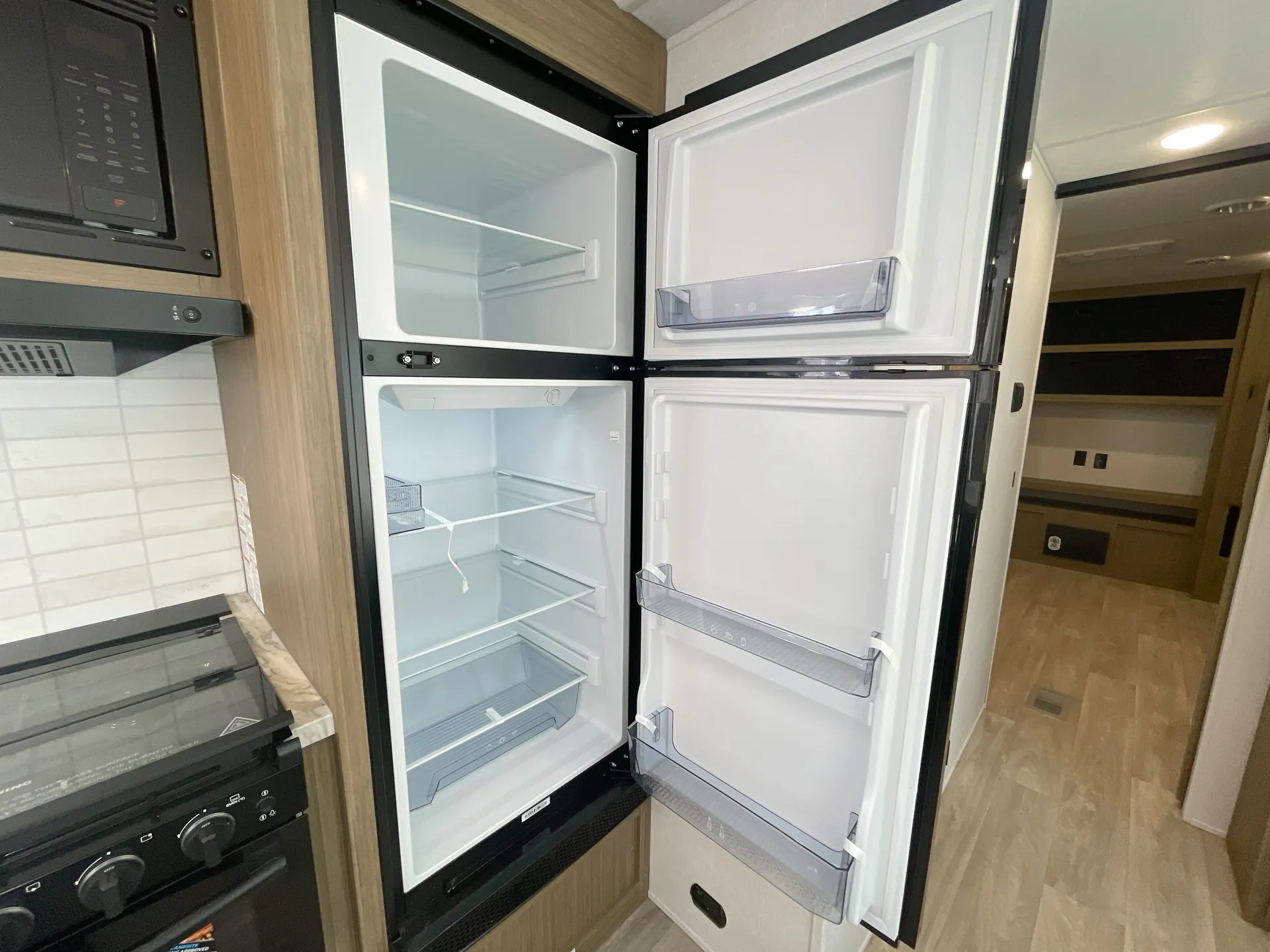 2027 Forest River Wildwood 31KQBTS — fridge open
