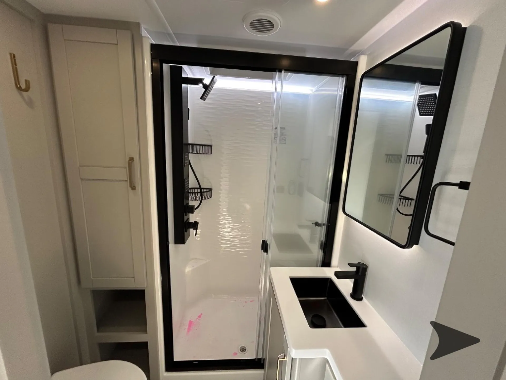 2026 Brinkley Model Z 3515 — Bathroom with glass-enclosed shower, black sink and faucet, mirrored cabinet, toilet, and storage