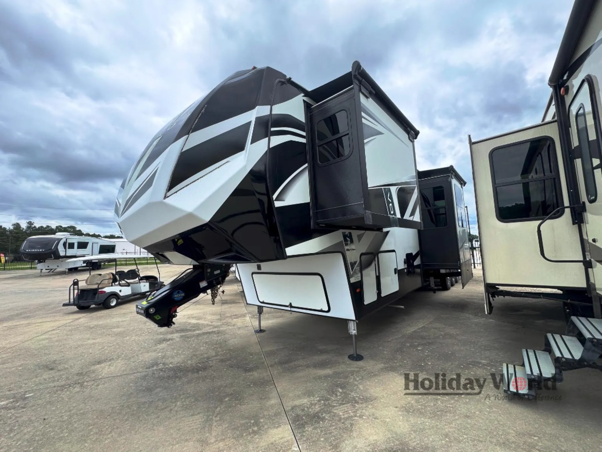2022 Dutchmen Voltage 4225 — Exterior three-quarter view visibly shows the RV shell, front cap, slide-outs, awnings, hitch, and landing gear