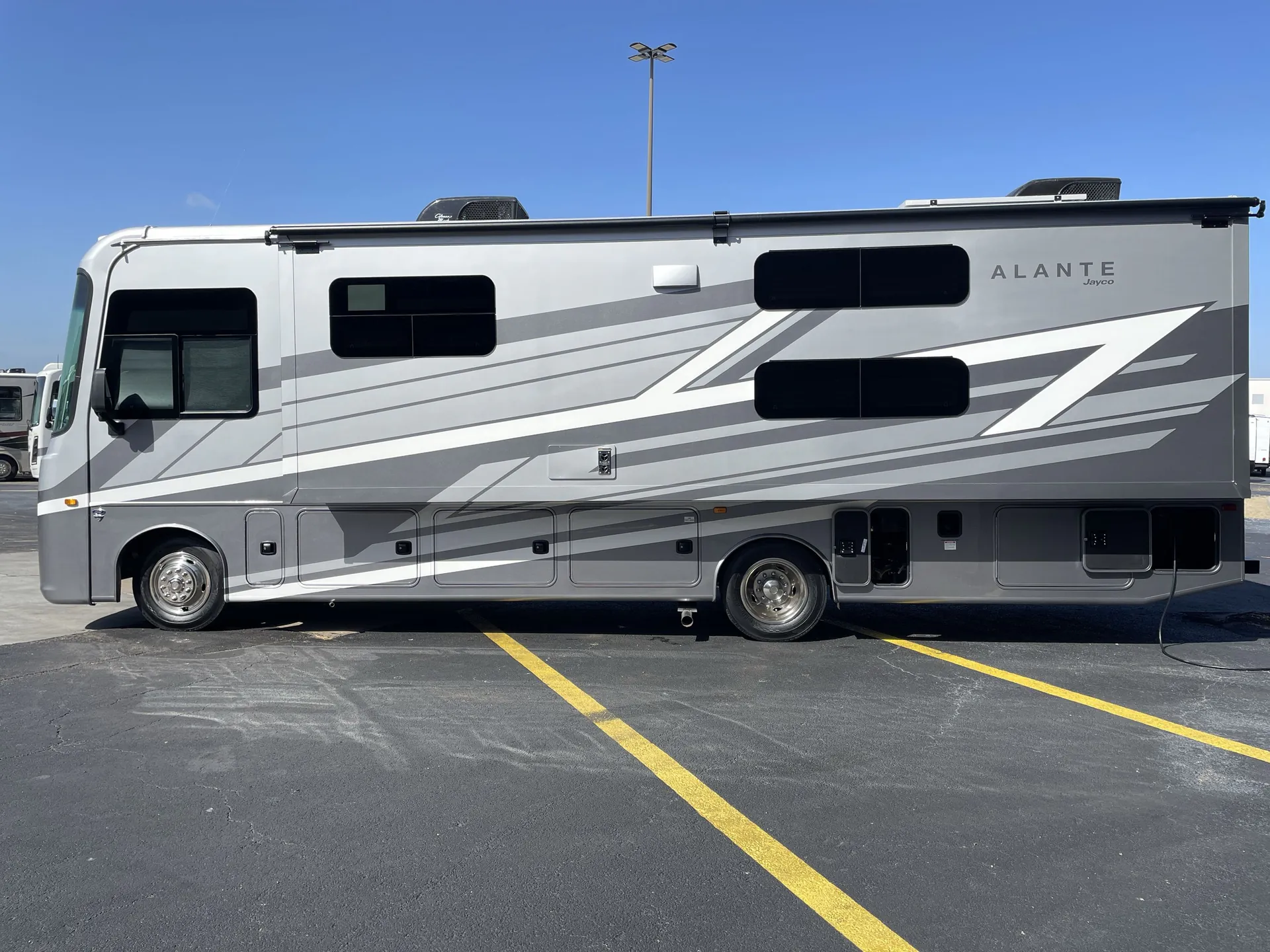 2027 Jayco Alante 29F — The full exterior side of the motorhome, including windows, awning, wheels, and body