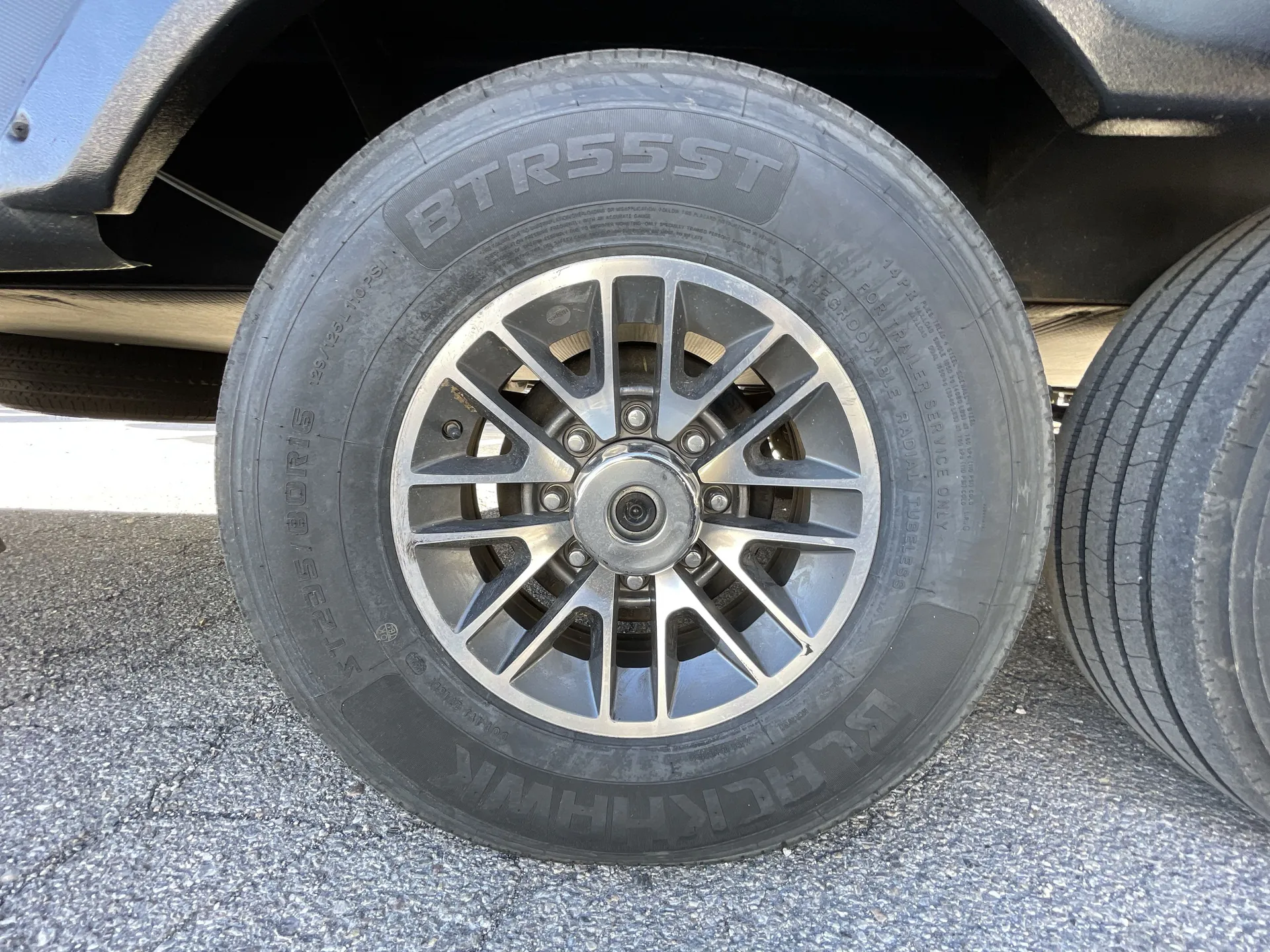 2023 Dutchmen Voltage 4225 — Close-up photograph visibly shows the RV's exterior wheel and tire