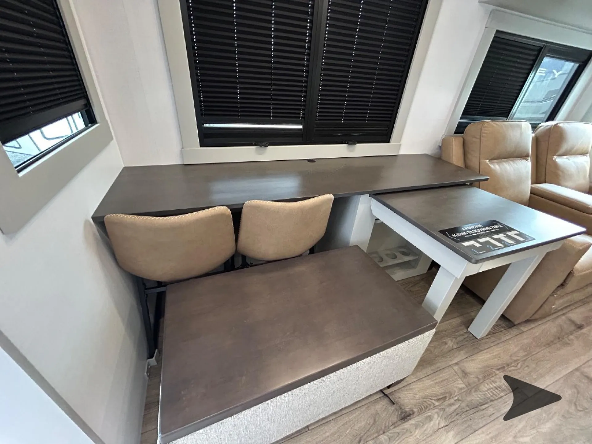 2026 Brinkley Model Z 3515 — Fifth wheel dinette with bench and chairs beside two reclining lounge seats and a sliding dining table