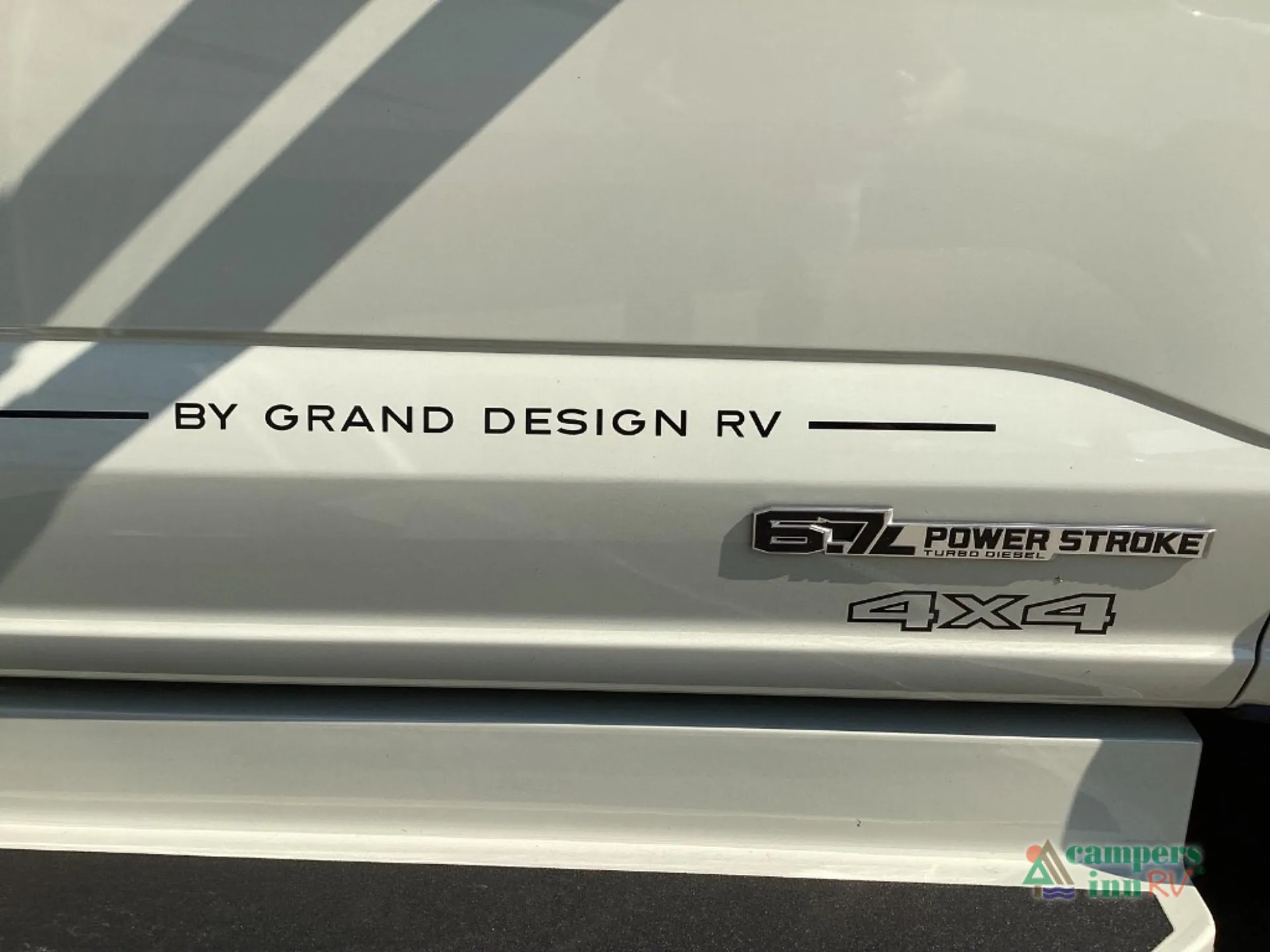 2027 Grand Design Lineage Series F 31ZW — Photograph of exterior RV bodywork with Power Stroke and 4x4 badges