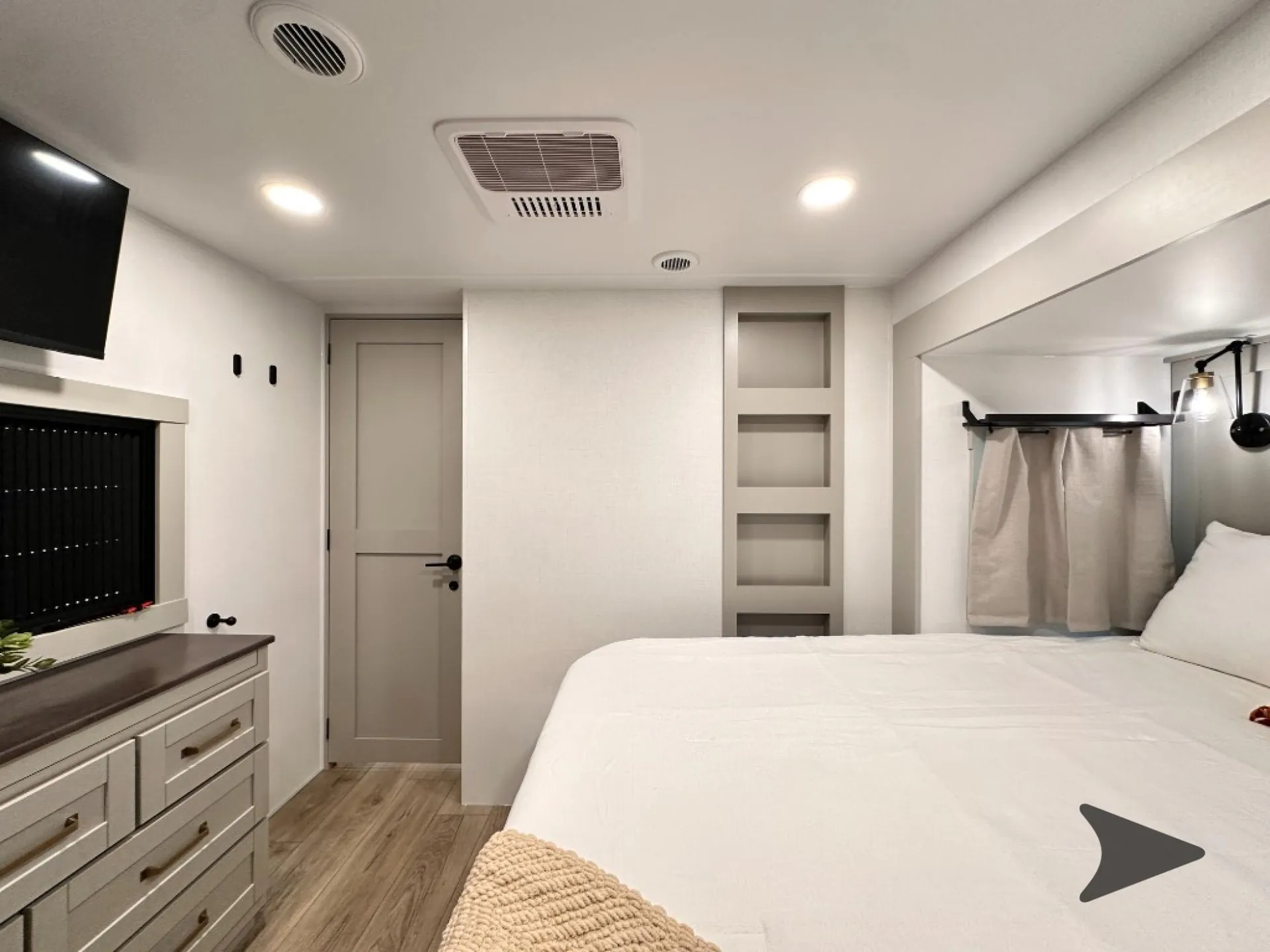 2026 Brinkley Model Z 3610 — Main bedroom with a bed, dresser and television, entry door, shelving, and curtained side window