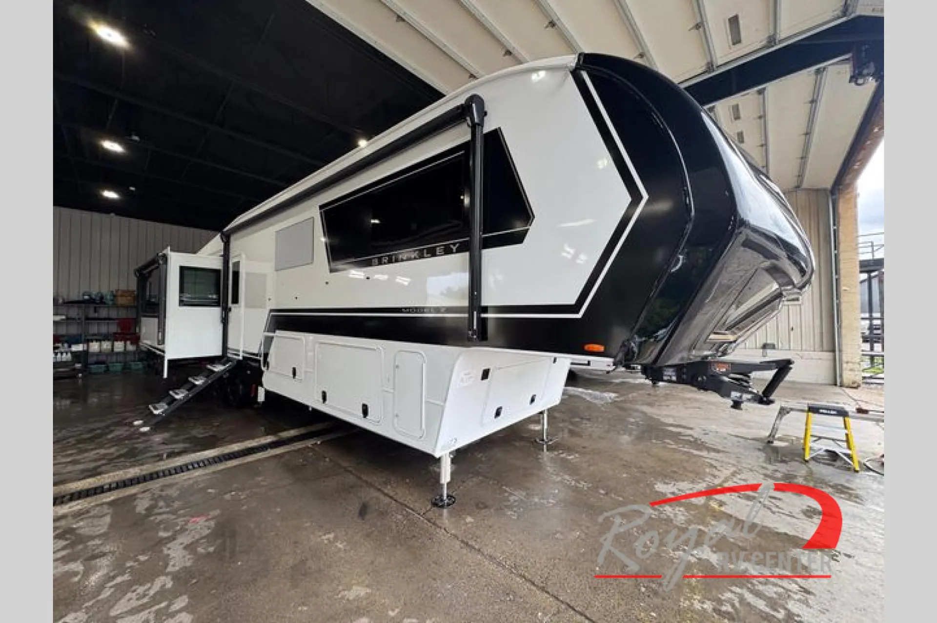 2026 Brinkley Model Z 3610 — The front and side exterior shell of a fifth-wheel RV, including hitch, awning hardware, and exterior storage
