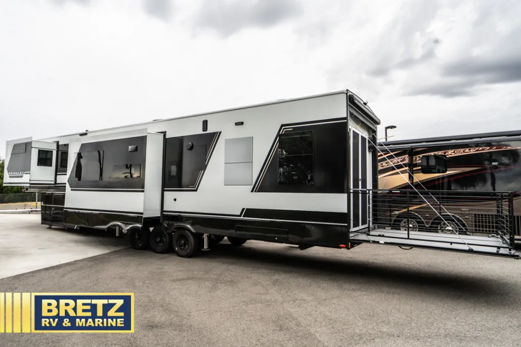 2026 Brinkley Model G 3950 — The opposite exterior side of the RV, including slide-outs, wheels, and rear patio