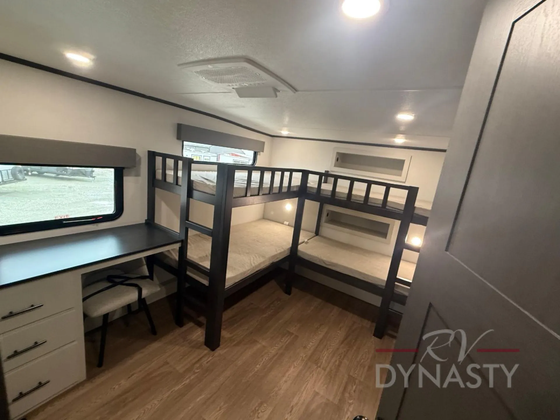 2027 Forest River Sanibel 40BUNK — Fifth wheel bunk bedroom with two bunk beds, desk, dresser, windows, and overhead cabinets