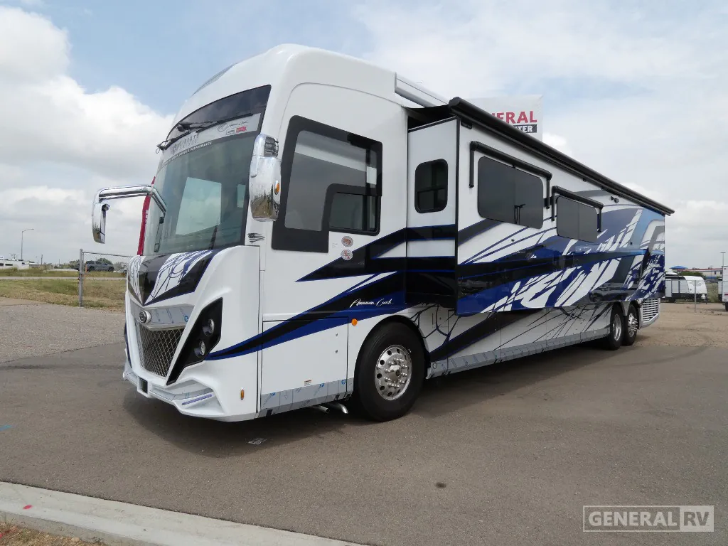 2026 American Coach American Dream 45A — The motorhome's front-left exterior, side graphics, windows, and slide-outs