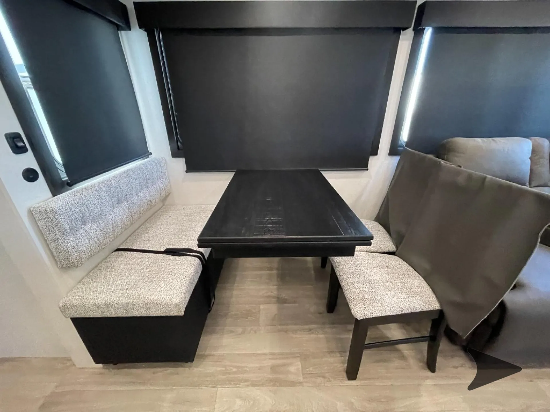 2027 Jayco Eagle 355MBQS — Dinette with upholstered bench seating, two chairs, table, windows, and a roller shade