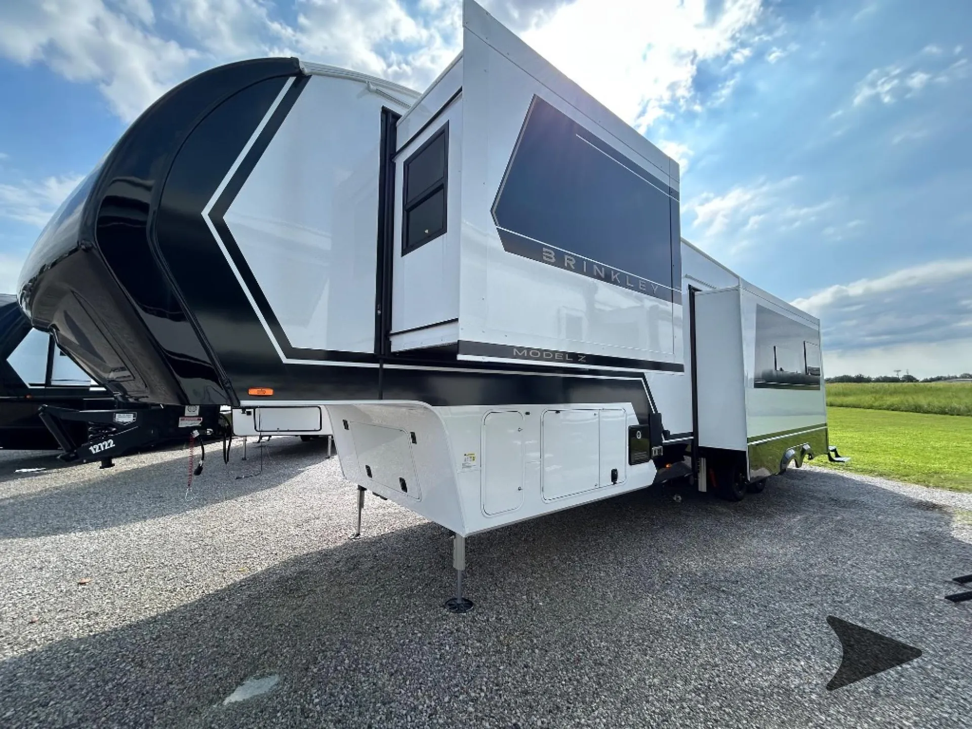 2026 Brinkley Model Z 3515 — The exterior front and side of the fifth-wheel RV with slide-outs and exterior compartments