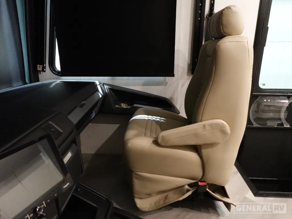 2026 Holiday Rambler Invicta 36Y — Motorhome passenger cockpit with captain’s chair, dashboard console, windshield, cupholder, and side entry door