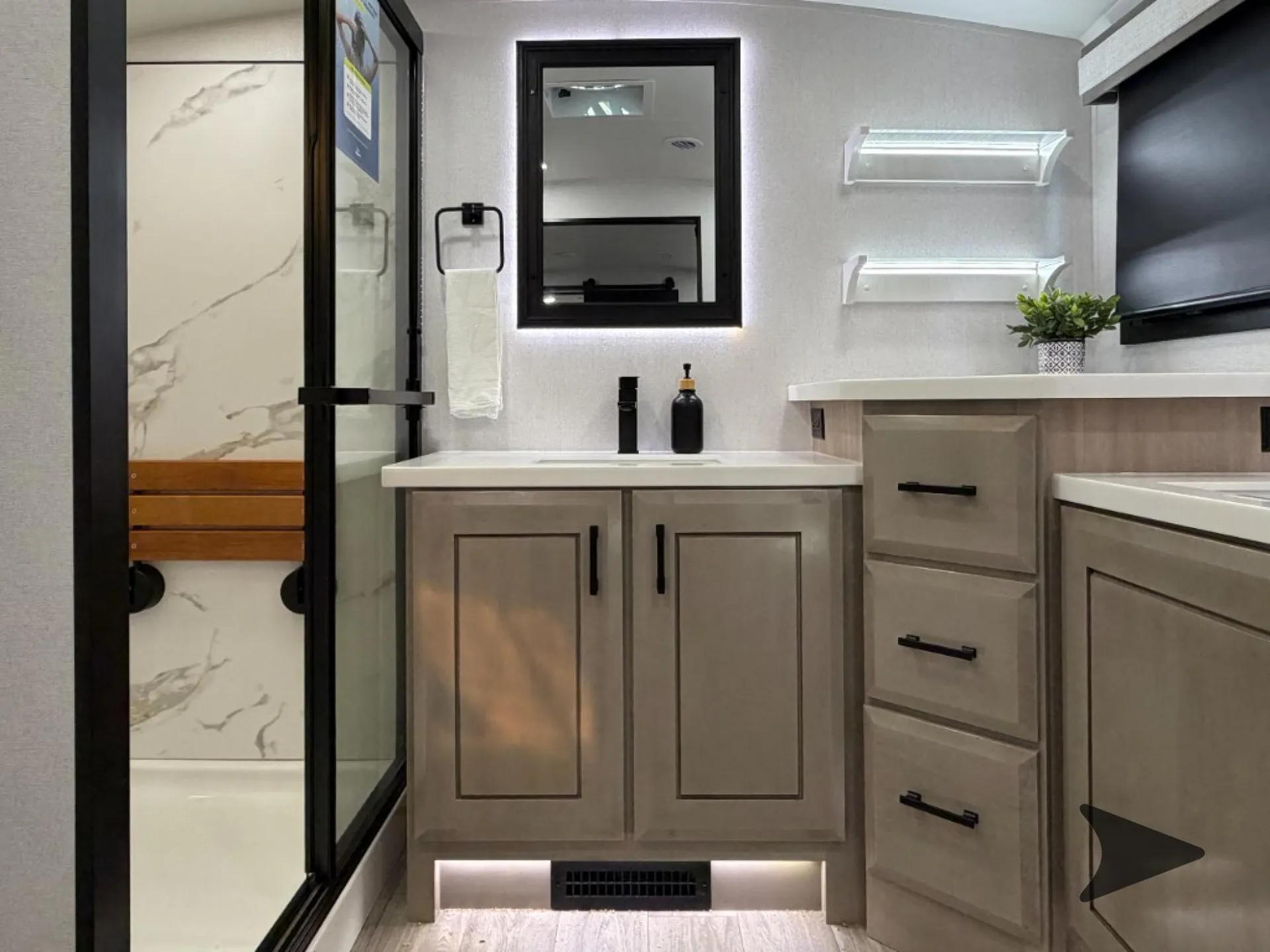 2027 Jayco Pinnacle 39FLOK — Bathroom vanity with sink, mirror, drawers, illuminated cabinetry, and glass-enclosed shower