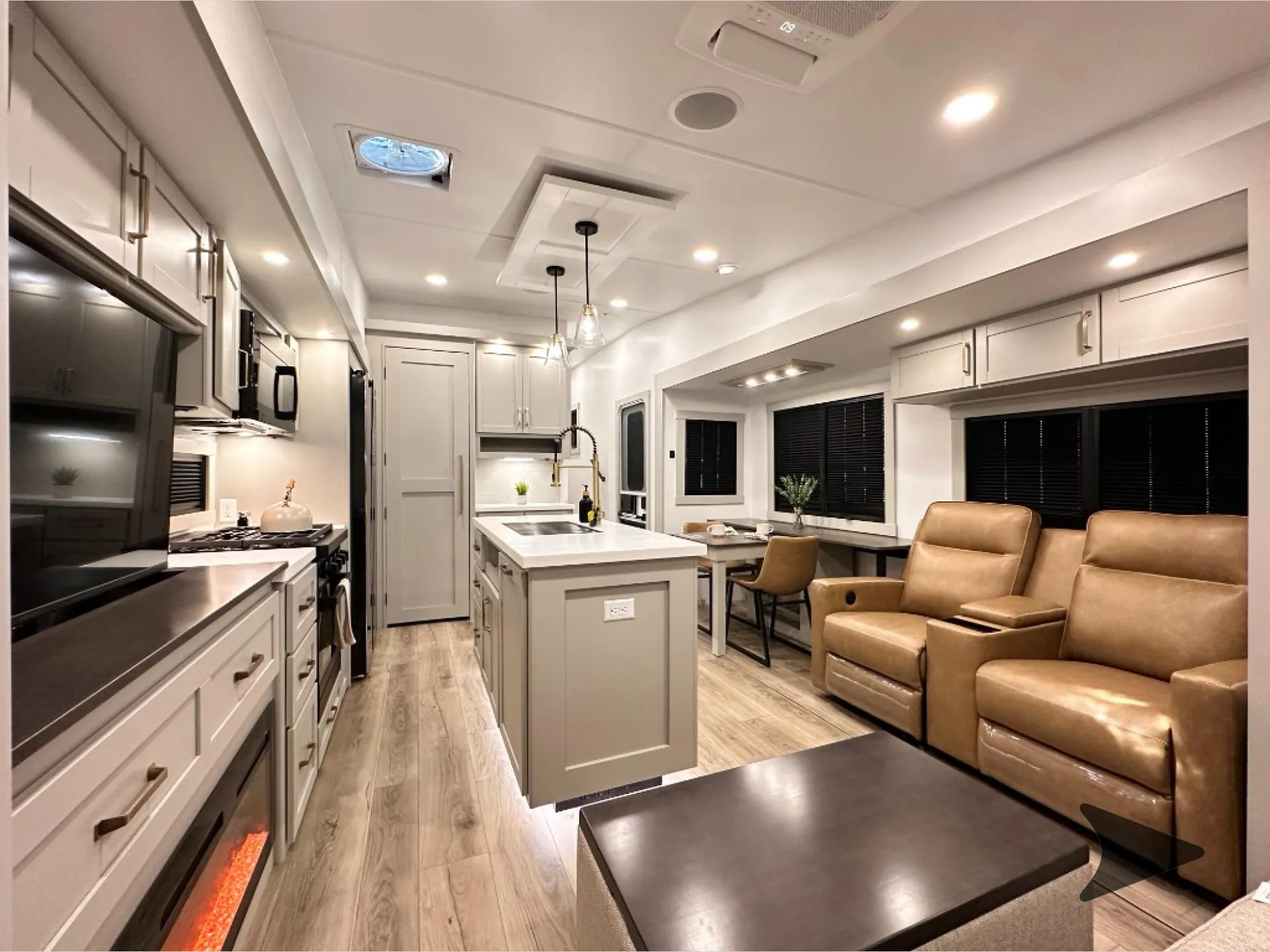 2026 Brinkley Model Z 3610 — Fifth wheel interior overview showing recliners and coffee table, kitchen counters and island, and dinette