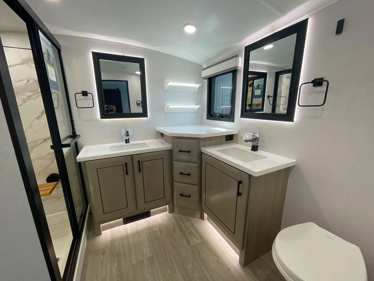 2027 Jayco Pinnacle 39FLOK — Fifth wheel bathroom with dual vanities, illuminated mirrors, corner counter, shower, and toilet