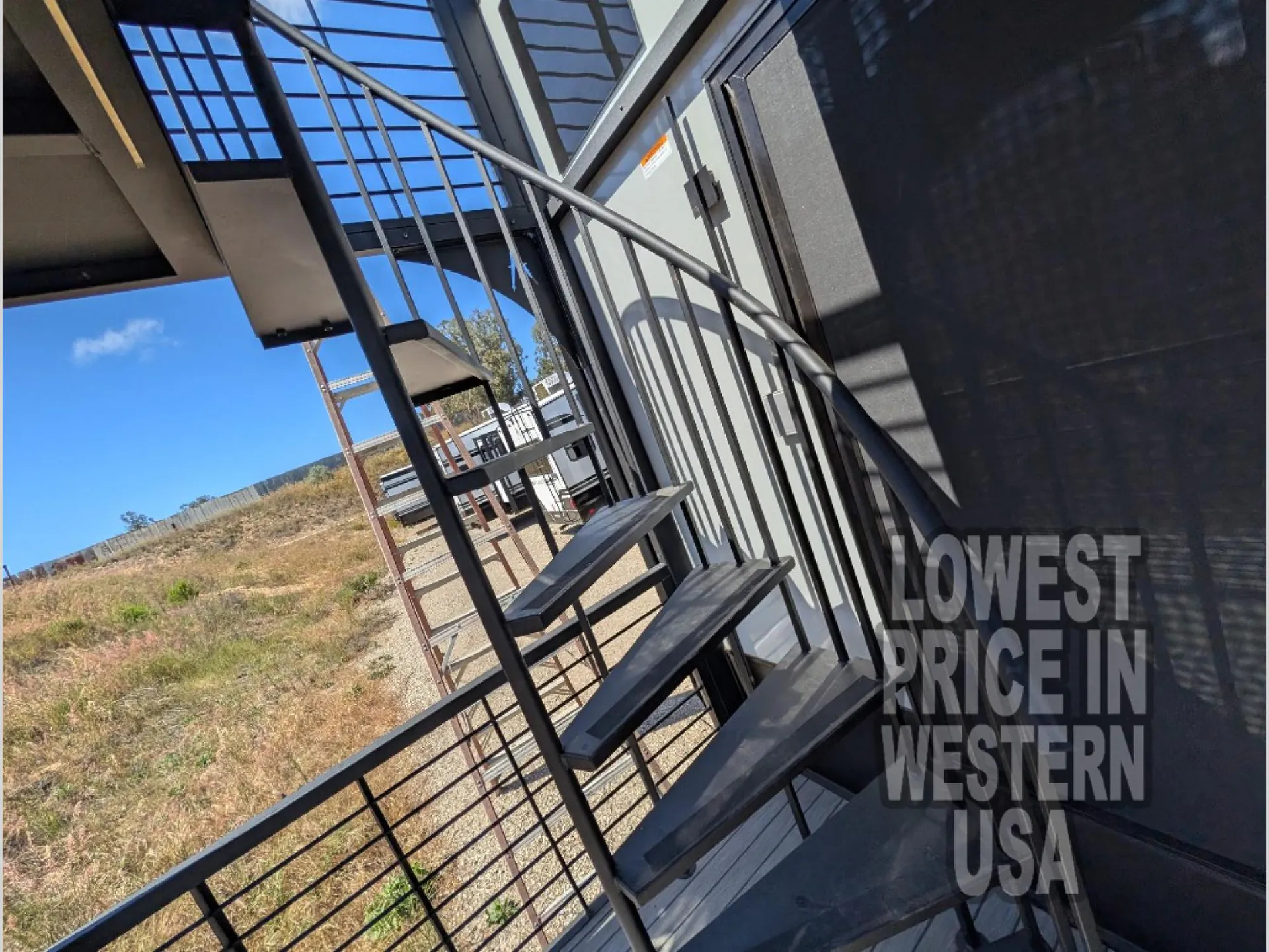 2026 Grand Design Foundation 42GD — Photograph visibly focuses on exterior stairs and railings leading to the RV entrance