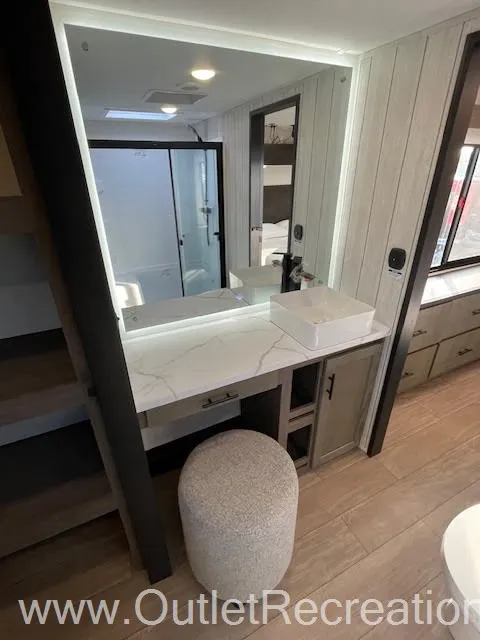 2026 Forest River Arctic Wolf 38LEAH.G — Fifth wheel bathroom vanity with vessel sink, marble-look countertop, mirrored cabinet, and adjacent shower doorway