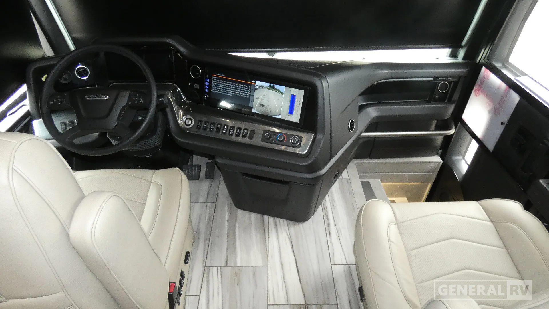 2026 American Coach American Dream 45A — Class A cockpit overview with steering wheel, dashboard touchscreen, passenger seat, entry steps, and windshield controls