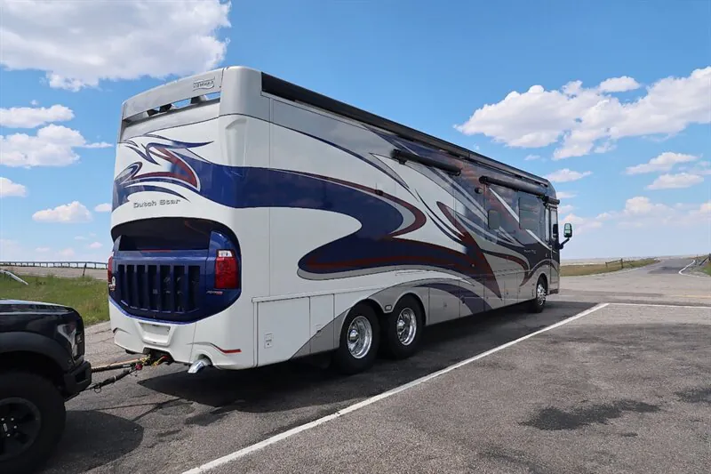 2016 Newmar Dutch Star 4369 — Photograph clearly shows the rear and side exterior of the motorhome, including body panels, wheels, and hitch