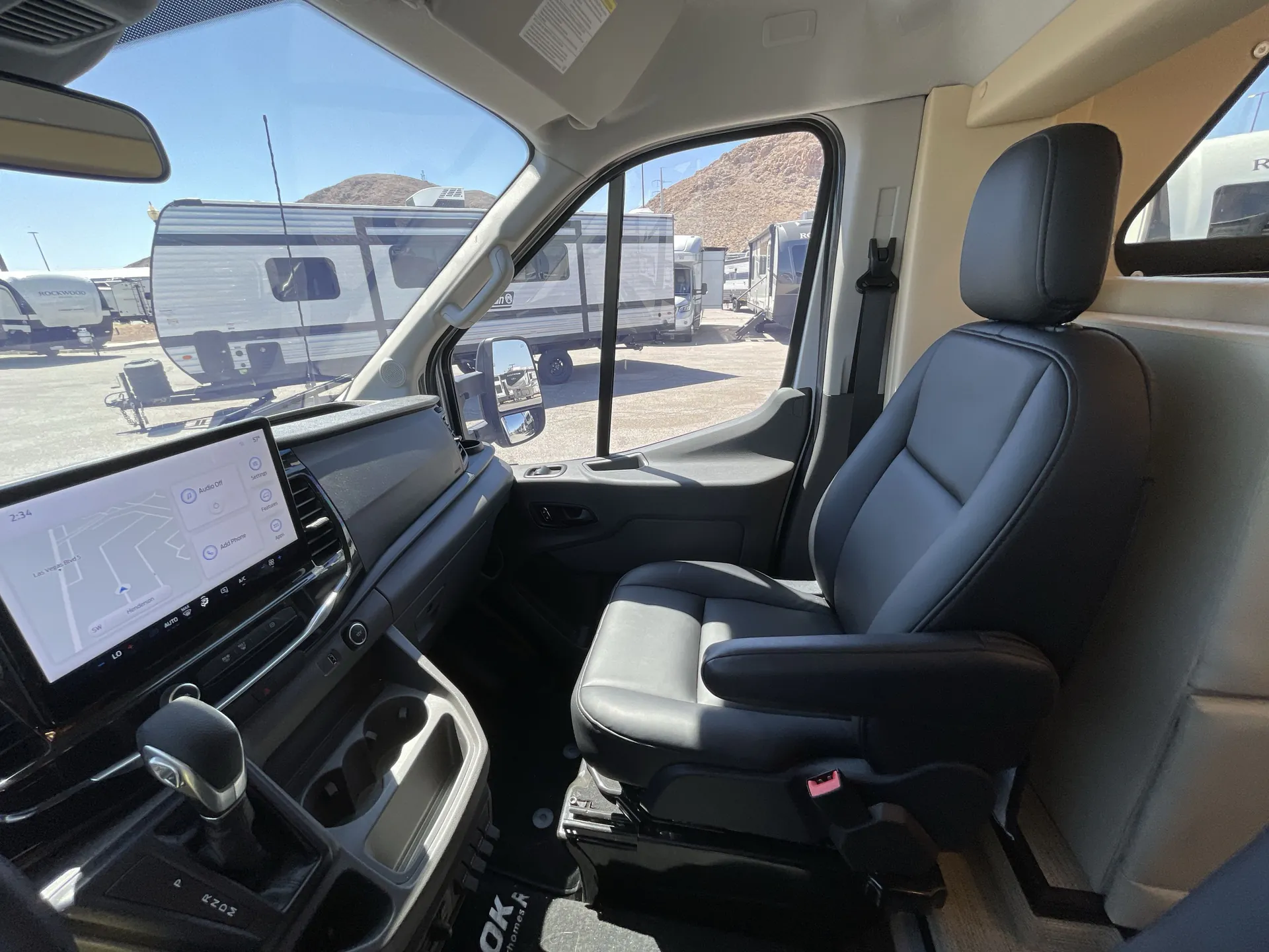 2024 Chinook RV Maverick SS — Passenger-side cockpit showing dashboard touchscreen, gear selector, cup holders, and front passenger seat