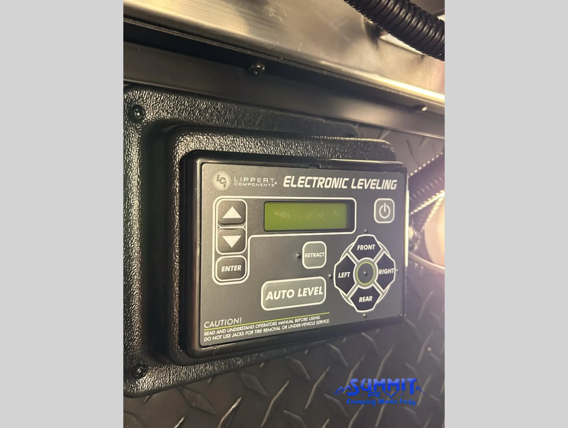2027 Grand Design Reflection 362TBS — Electronic leveling control is visibly mounted in an exterior diamond-plate service area