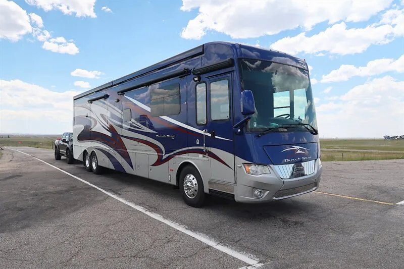 2016 Newmar Dutch Star 4369 — Front three-quarter photograph visibly shows the motorhome exterior, windshield, front cab, wheels, and side body