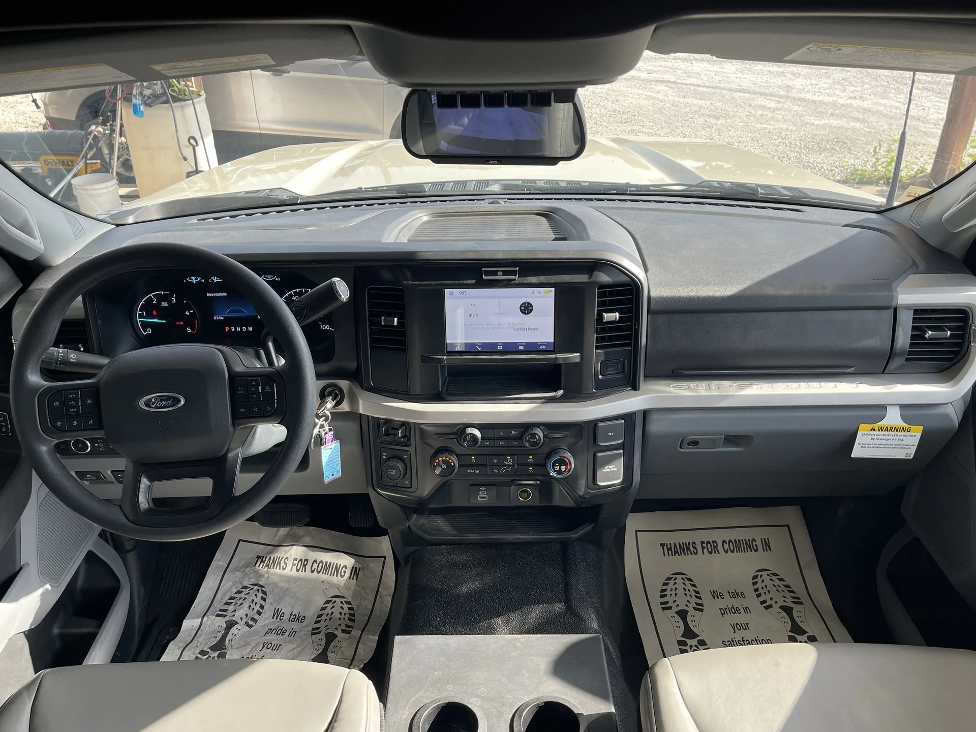 2027 Grand Design Lineage Series F 31ZW — Front cockpit dashboard with steering wheel, instrument panel, infotainment screen, climate controls, and windshield