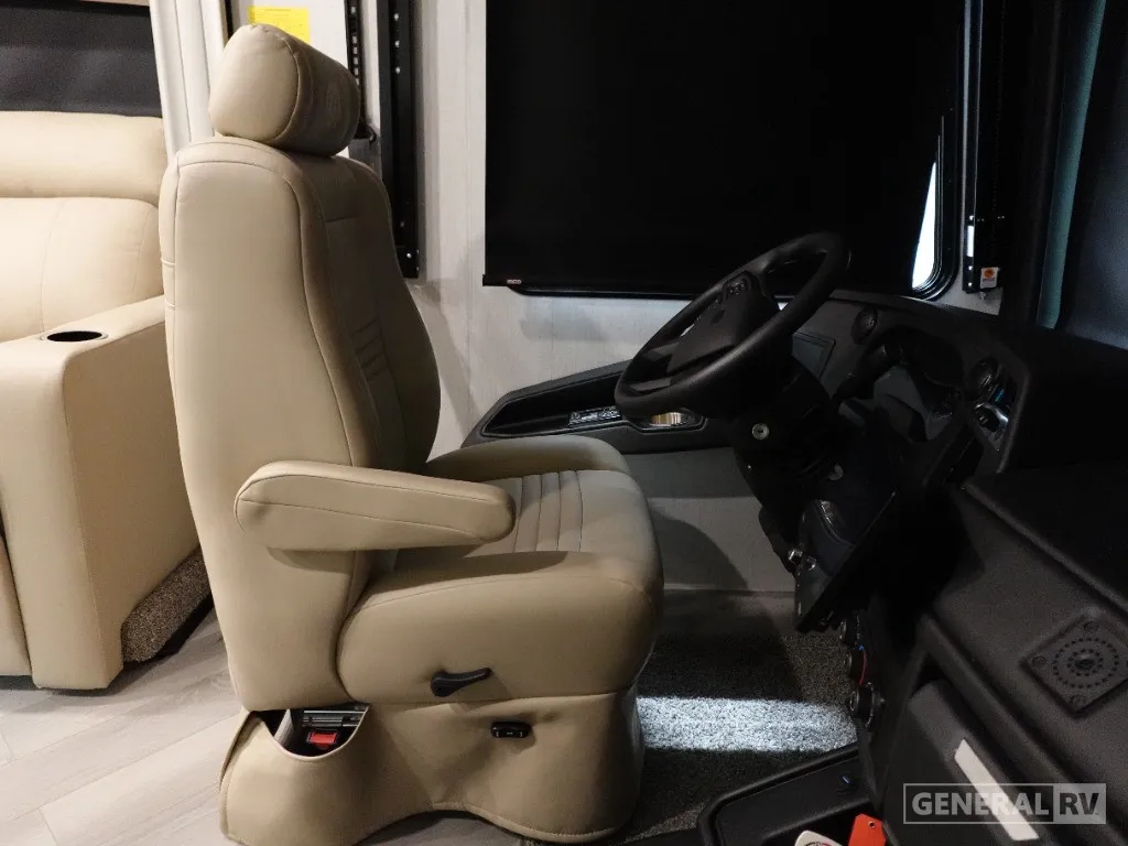2026 Holiday Rambler Invicta 36Y — Motorhome driver cockpit with steering wheel, instrument panel, driver’s seat, pedals, and windshield controls
