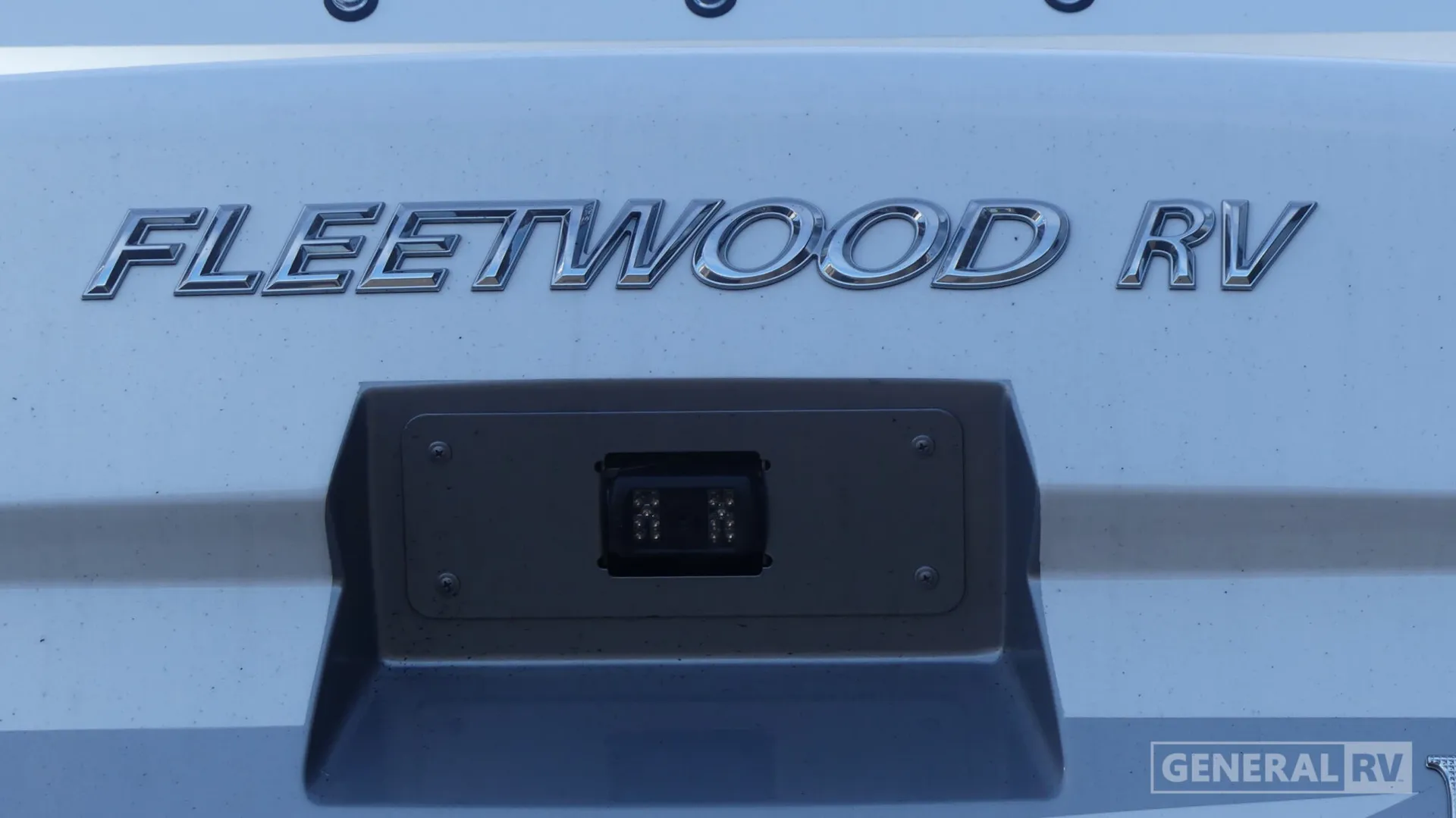 2026 Fleetwood Discovery LXE 40G — Close-up visibly shows the Fleetwood RV exterior body and mounted exterior light